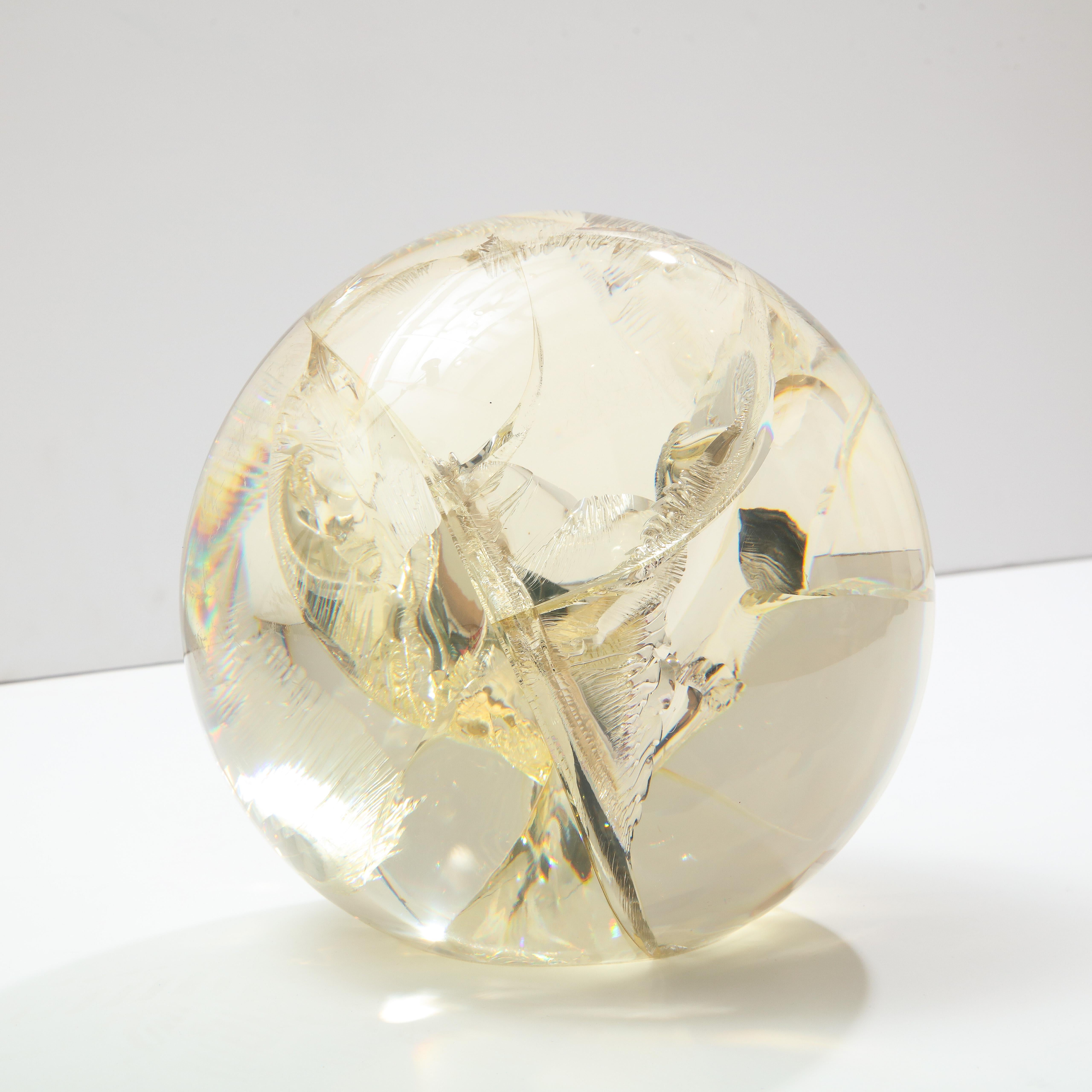 Pierre Giraudon fractured resin sphere, sculpture, clear and yellow gold. Medium scale tabletop acrylic sculpture with internal fractured inclusions and colored with a yellow gold tint. The base of the sphere is flat for stable display (see photo