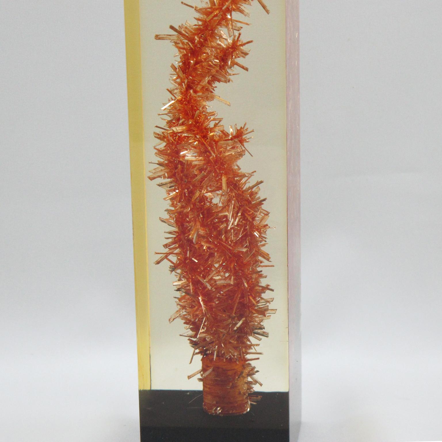 This unique Pierre Giraudon Resin table lamp with inclusions is a stunning statement piece. Crafted in the 1960s, the piece features a layered poured resin with orange coral-like inclusions and a black resin base. The natural yellowish coloration of