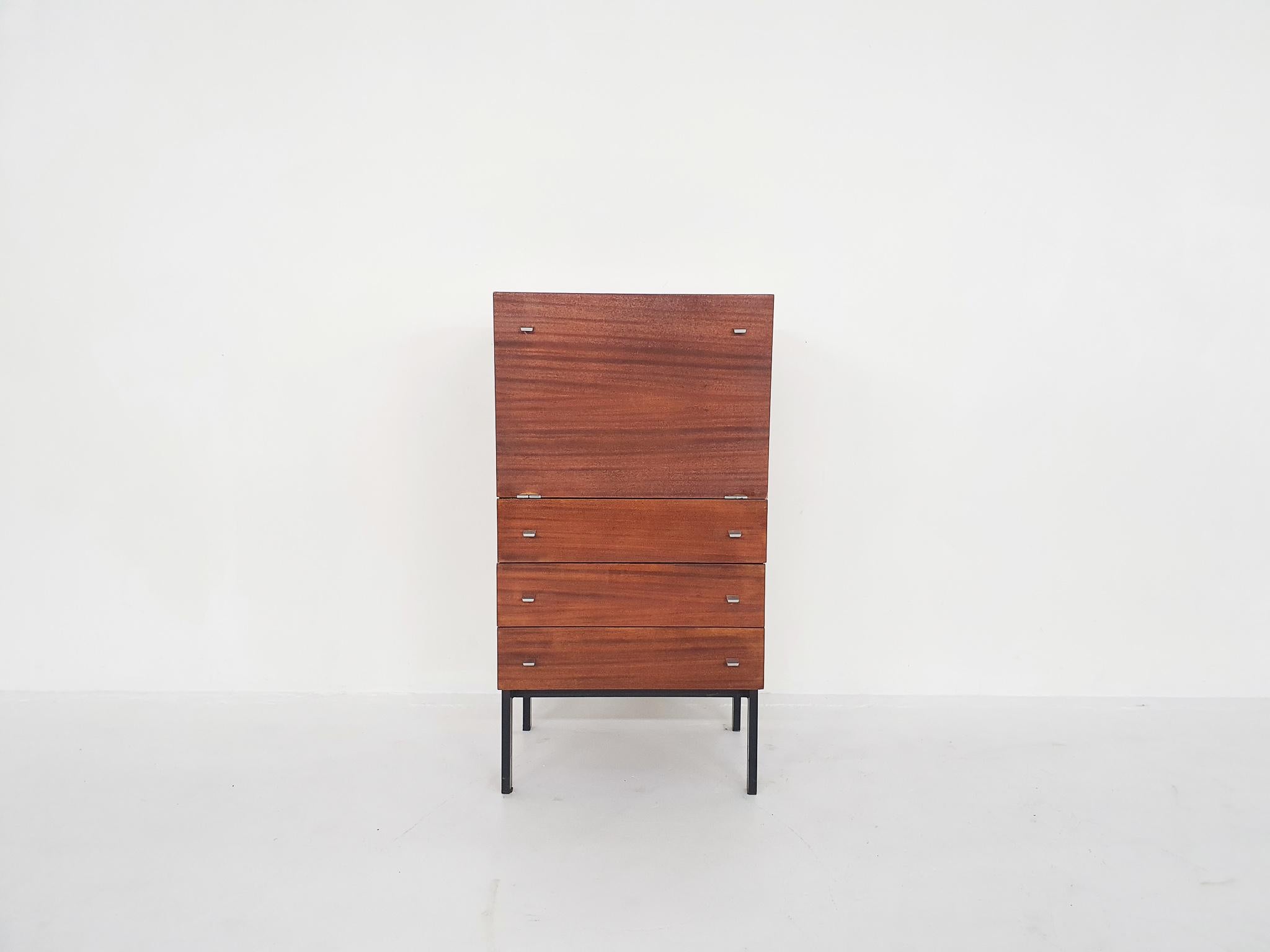 A writing cabinet or bar cabinet by French architect Pierre Guariche. Designed for Meurop Belgium in the 1960s.

This beautiful cabinet can be used for multiple purposes. You can store your items in its drawers and use the drop door as a desk, so