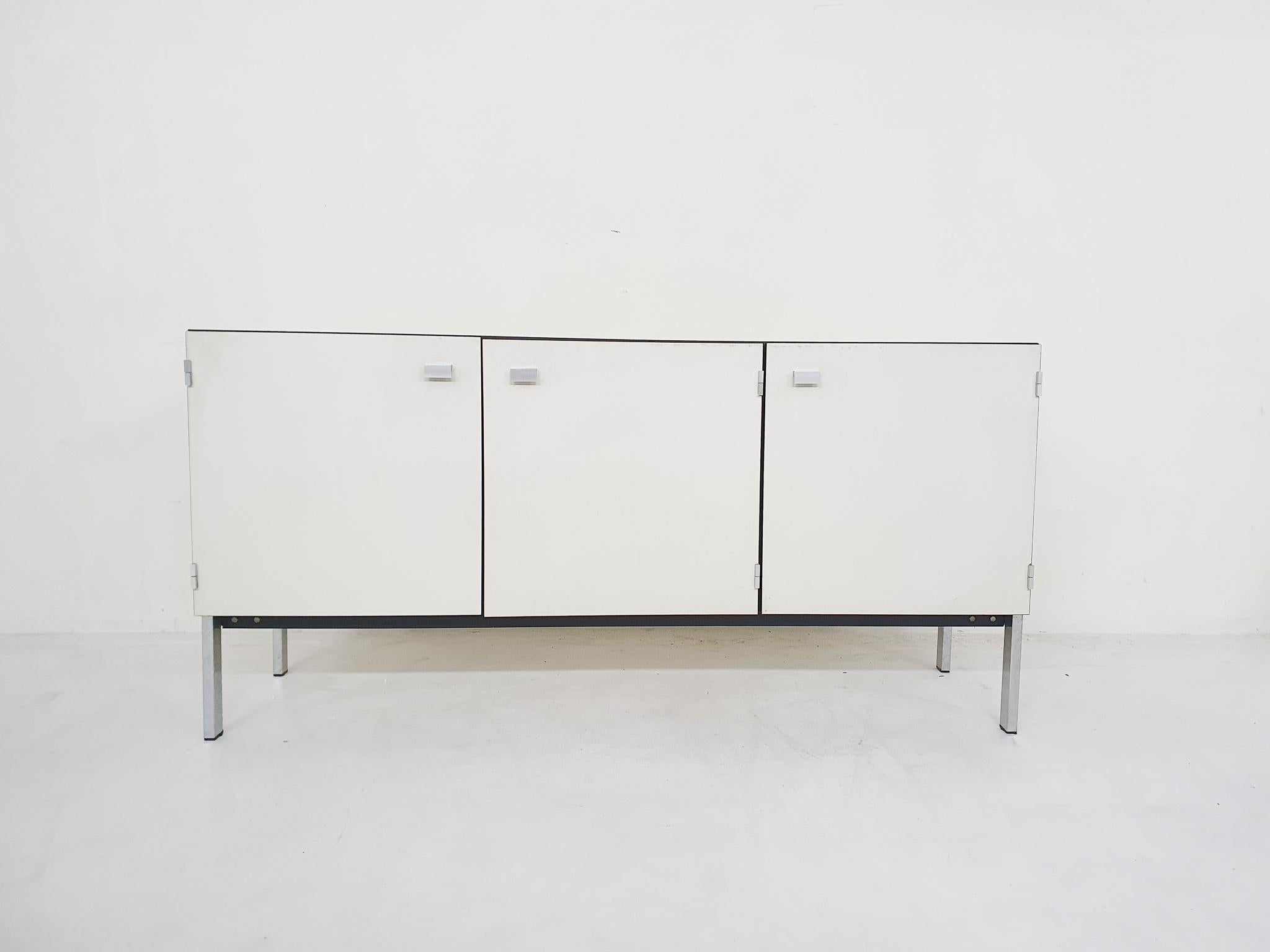Sideboard by Pierre Guariche for Meurop. The cabinet is covered in white and brown faux leather.
On a metal frame.