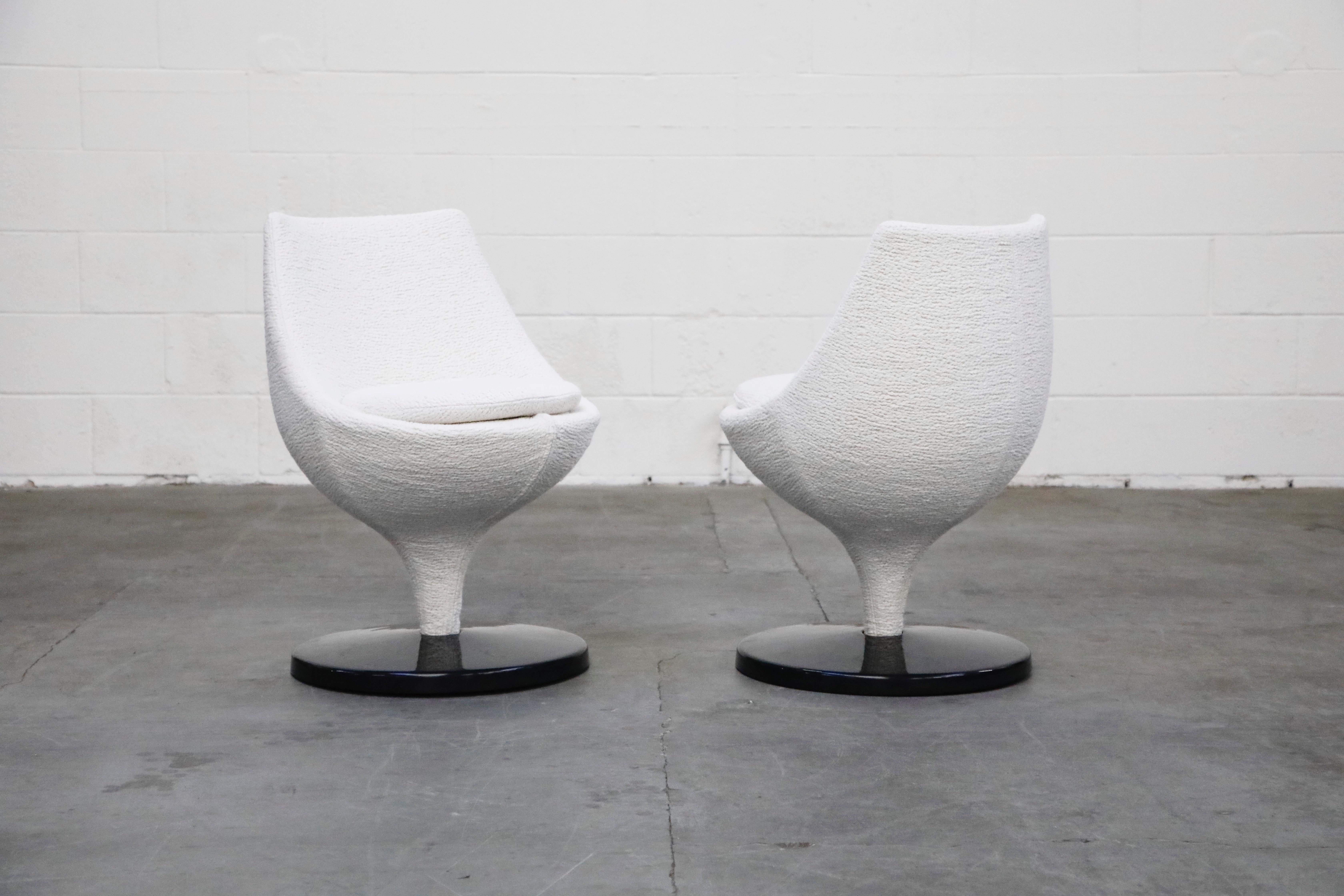 A pair of beautiful Pierre Guariche for Meurop circa 1965 'Polaris' swivel chairs in a highly textured white boucle fabric and black fiberglass base. Pierre Guariche, a French designer and Meurop a Belgian maker. Recently reupholstered, in showroom