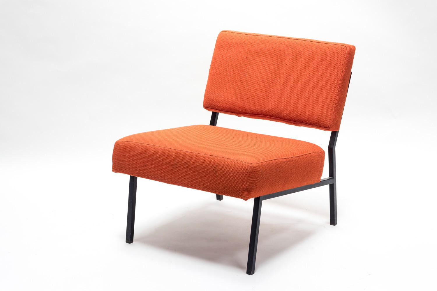 Pierre Guariche, in the style of.

Pair of fireside chairs with back and seat covered with an orange fabric and standing on four squared section legs in black lacquered metal. Stretchers link legs in each side of the fireside chairs.

Work