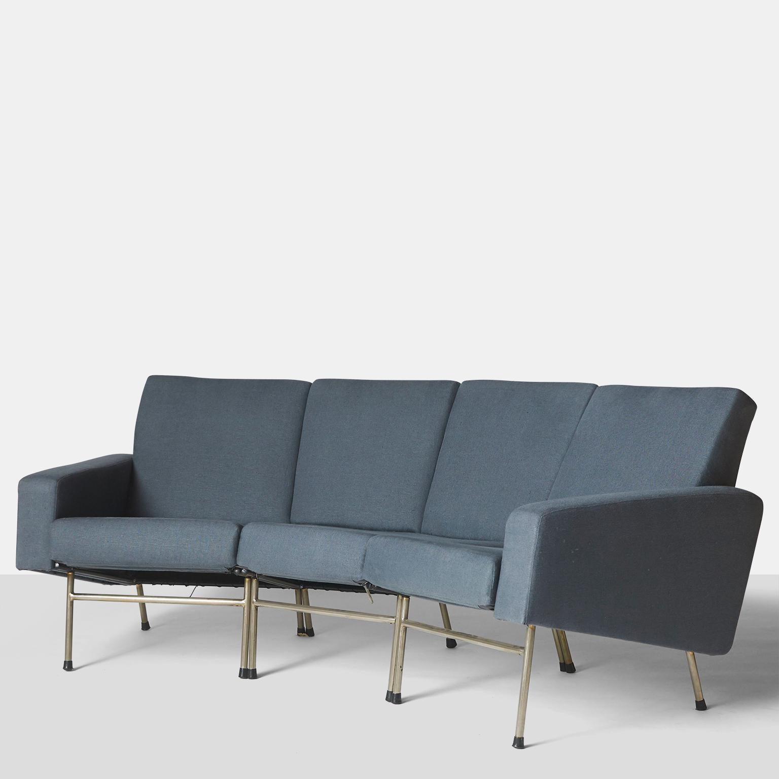 A curved, three-seat sofa by Pierre Guariche. Features chromed steel legs and sloped arm rests. Very comfortable and sleek. Model G10/4 for Airborne International.