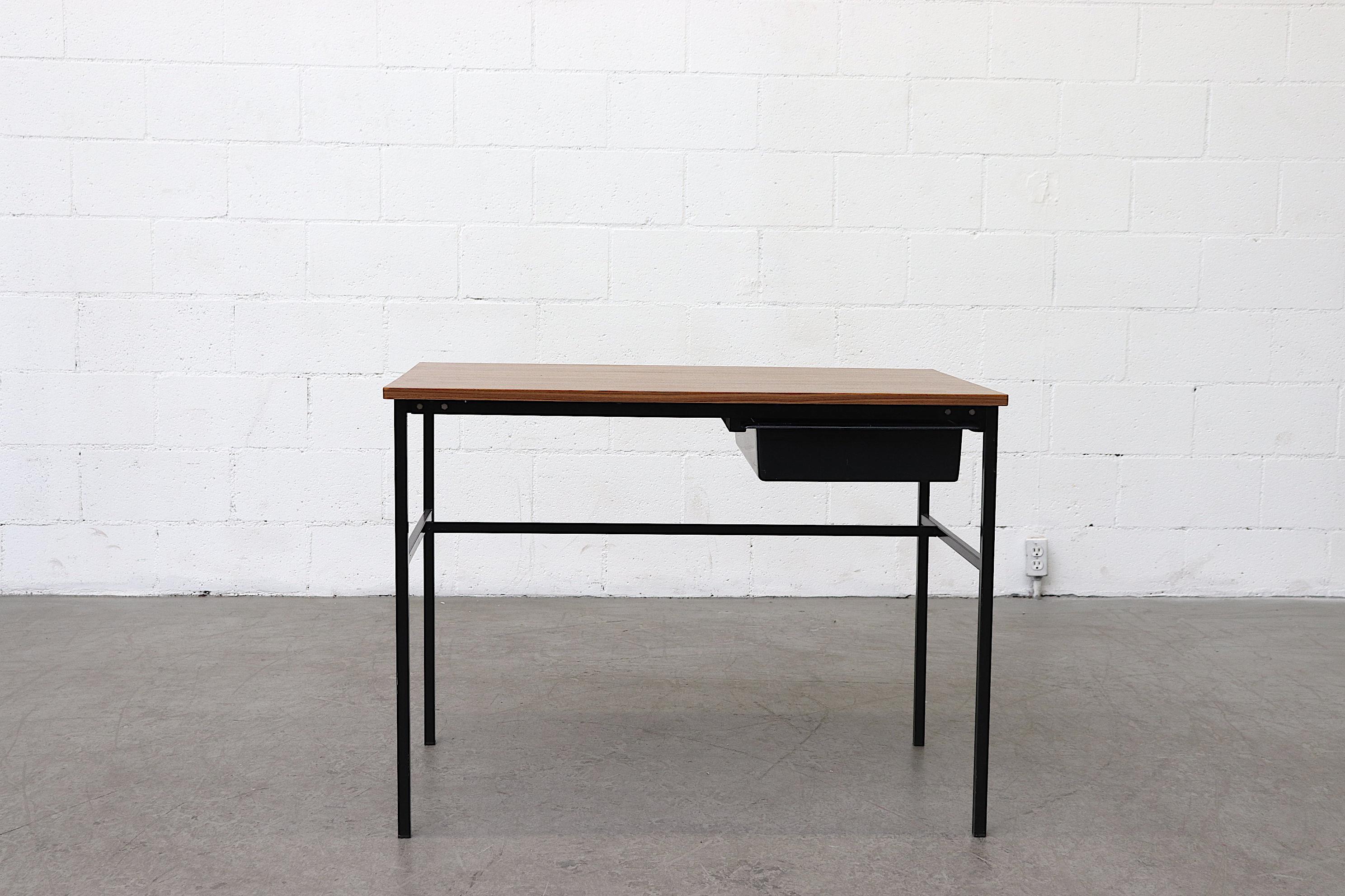 Streamline simple teak and enameled metal writing desk by Pierre Guariche for Meurop. Black plastic sliding drawer on right-hand side. Good condition.