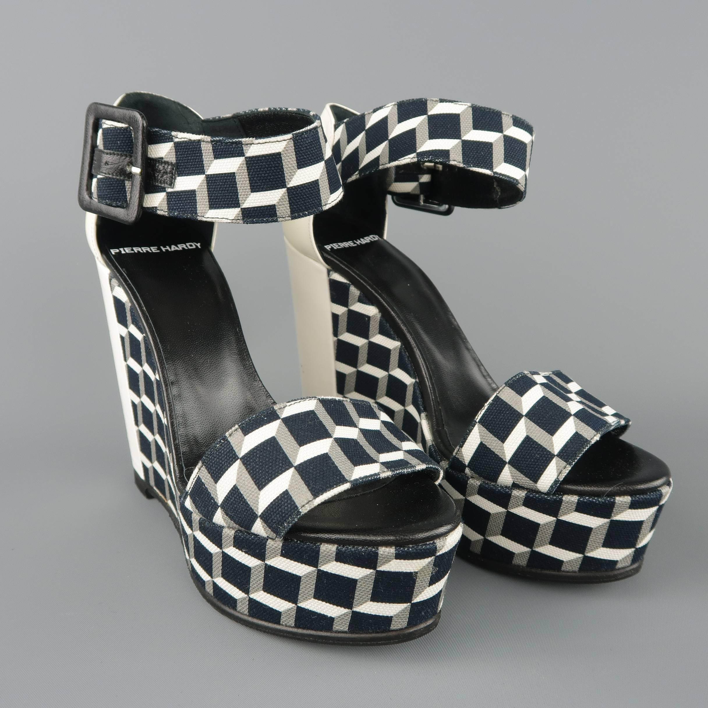 PIERRE HARDY sandals come in black and white geometric print canvas with a thick ankle strap white patent leather back panel, and covered platform wedge. White patent leather discolored. As-is.
 
Fair Pre-Owned Condition.
Marked: (no size)

