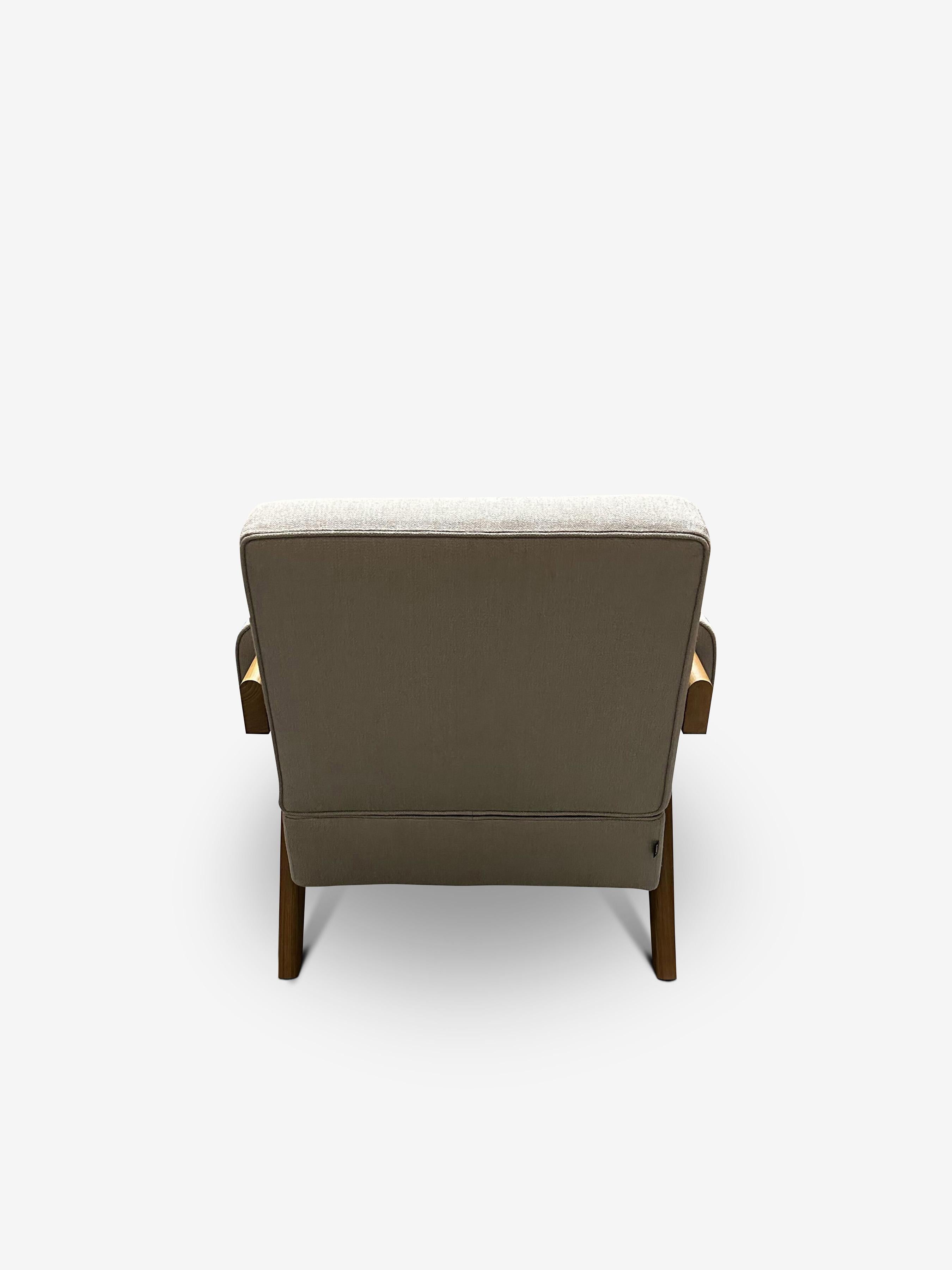 Experience mid-century modern design at its finest with the Pierre Jeanneret 1960 Capitol Complex Armchair. Crafted with teak wood and upholstered in luxurious Panna Lipari fabric, this armchair exudes timeless elegance. Its ergonomic design