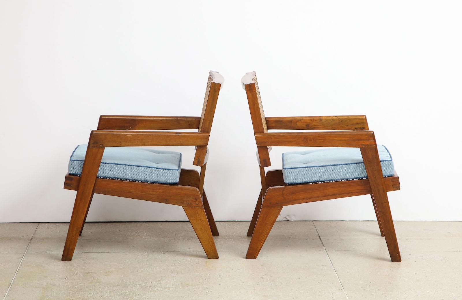 Rare pair of armchairs by Pierre Jeanneret. Open armchair model. Teak, rattan and upholstered cushion. Originally design for the University of Punjab, Chandigarh, India. Very good vintage condition with newly made seat cushions.