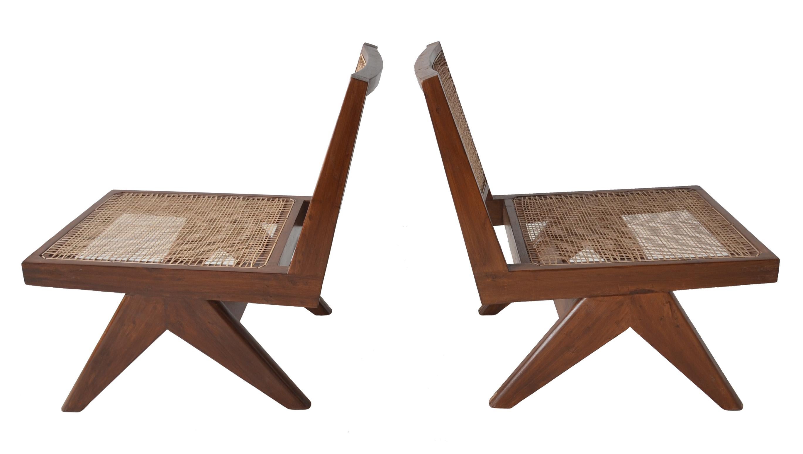 A terrific pair of rare armless low lounge chairs with caned seats by Pierre Jeanneret for the Chandigarh project.
Model PJ-SI-35-A circa 1960

Solid teak construction with caned seats and backs. 

These chairs have undergone a sympathetic