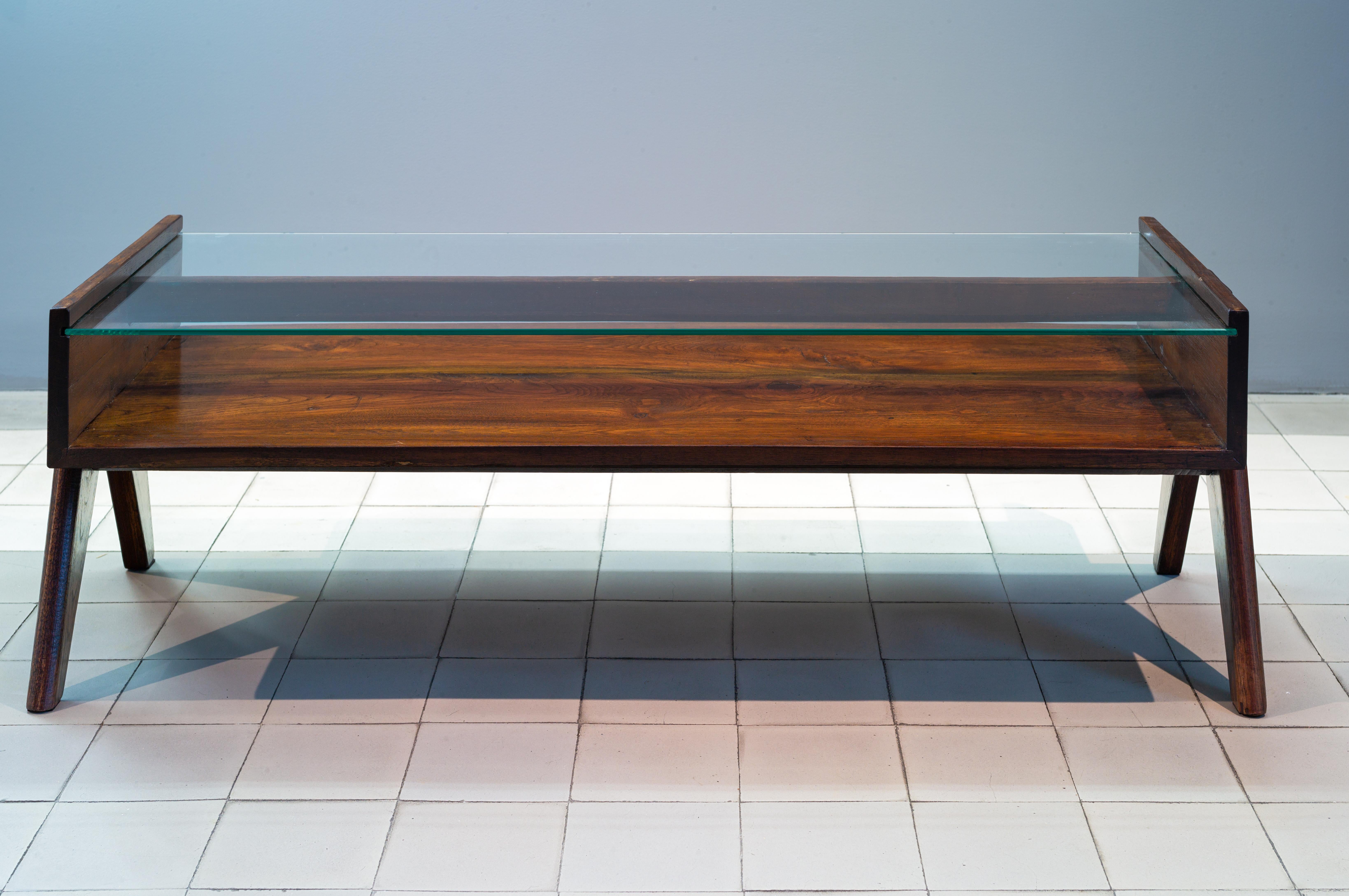 Pierre Jeanneret
PJ-TB-05-A
Important : vintage collector's item for sale with guaranteed authenticity. 
Rectangular coffee table with glass tabletop called “Coffee table”, circa 1960
Pair of «V” shaped legs bearing a open cabinet with a upper