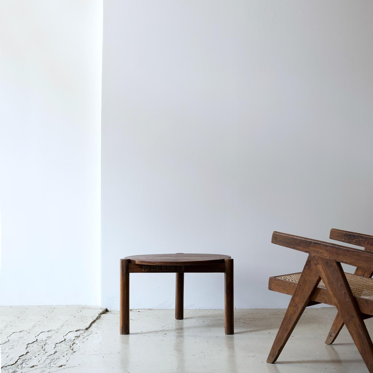 Teak coffee table designed by Pierre Jeanneret. Round top with three log-type legs.

Provenance: Post Graduate Institute, Chandigarh, India.