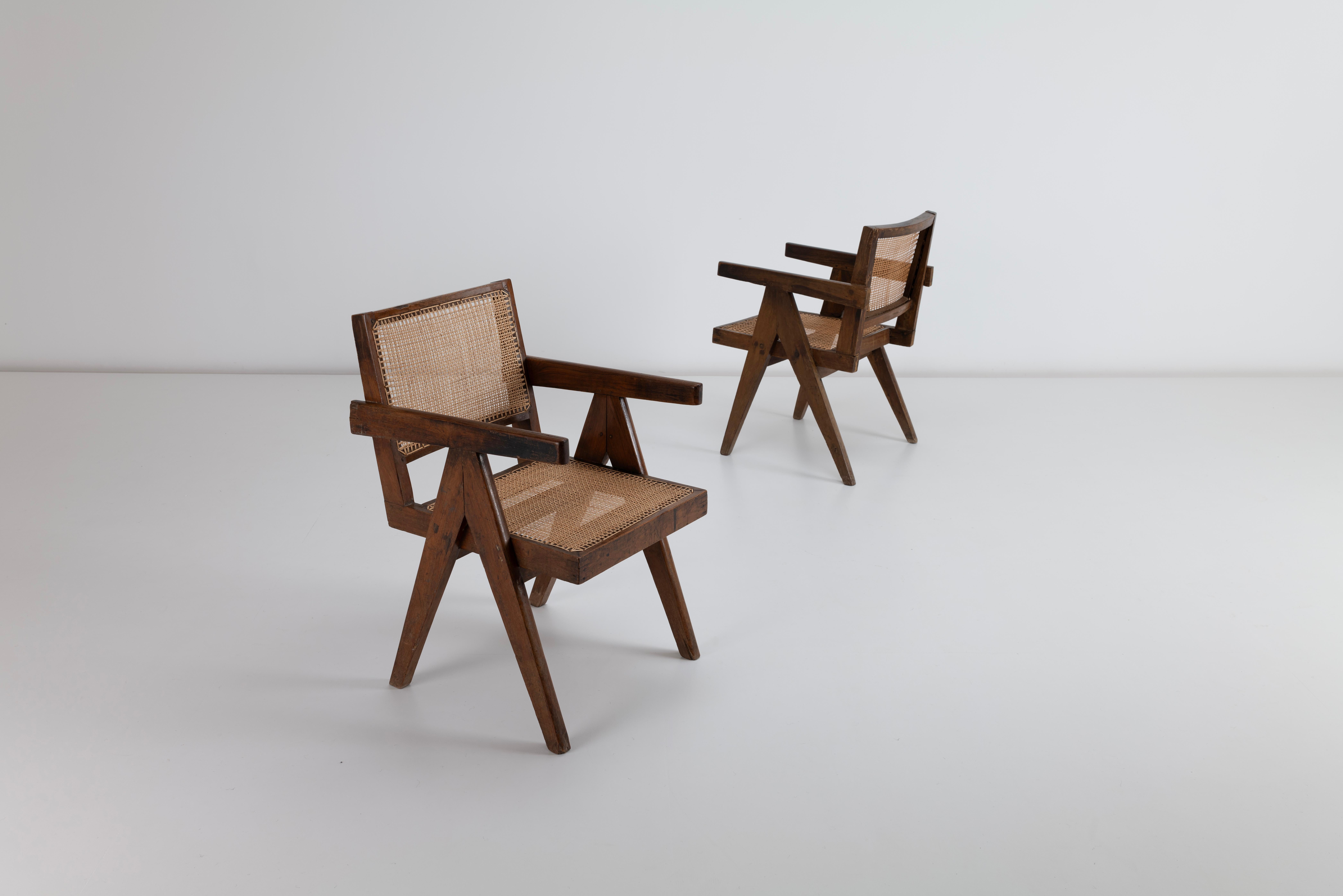 This exceptional pair of Pierre Jeanneret Conference armchairs, crafted in rosewood with their signature cane seat and back and ‘A’ frame, is a true masterpiece of mid-century modern design. Designed by Jeanneret for the brutalist city of