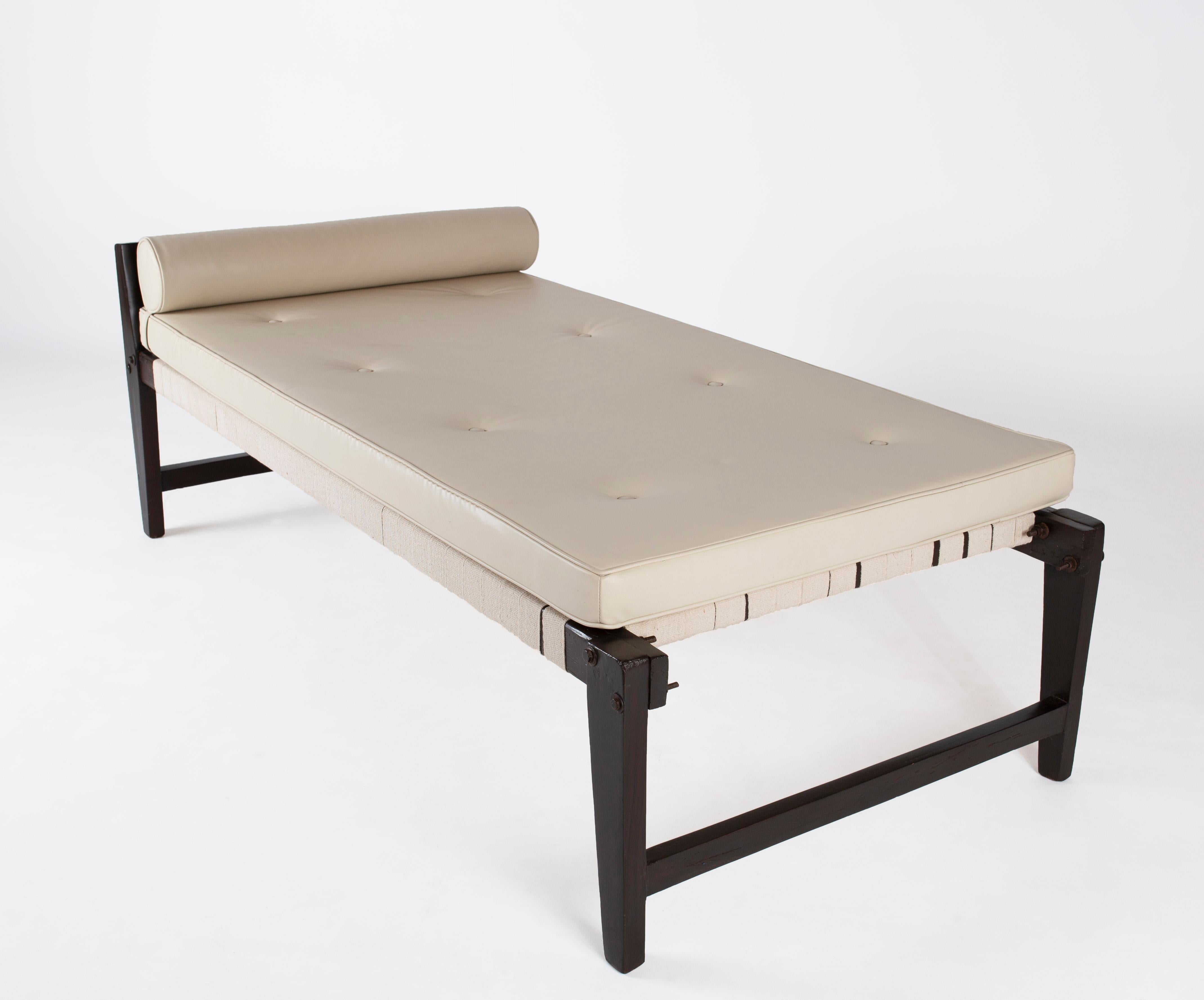 Pierre Jeanneret, De-mountable Daybed with Headrest in Stained Cedar Wood, Cotton Straps and Leather upholstery. 
Provenance: Commissioned for MLA Hostel and Flats, Private Residences, Chandigarh, India