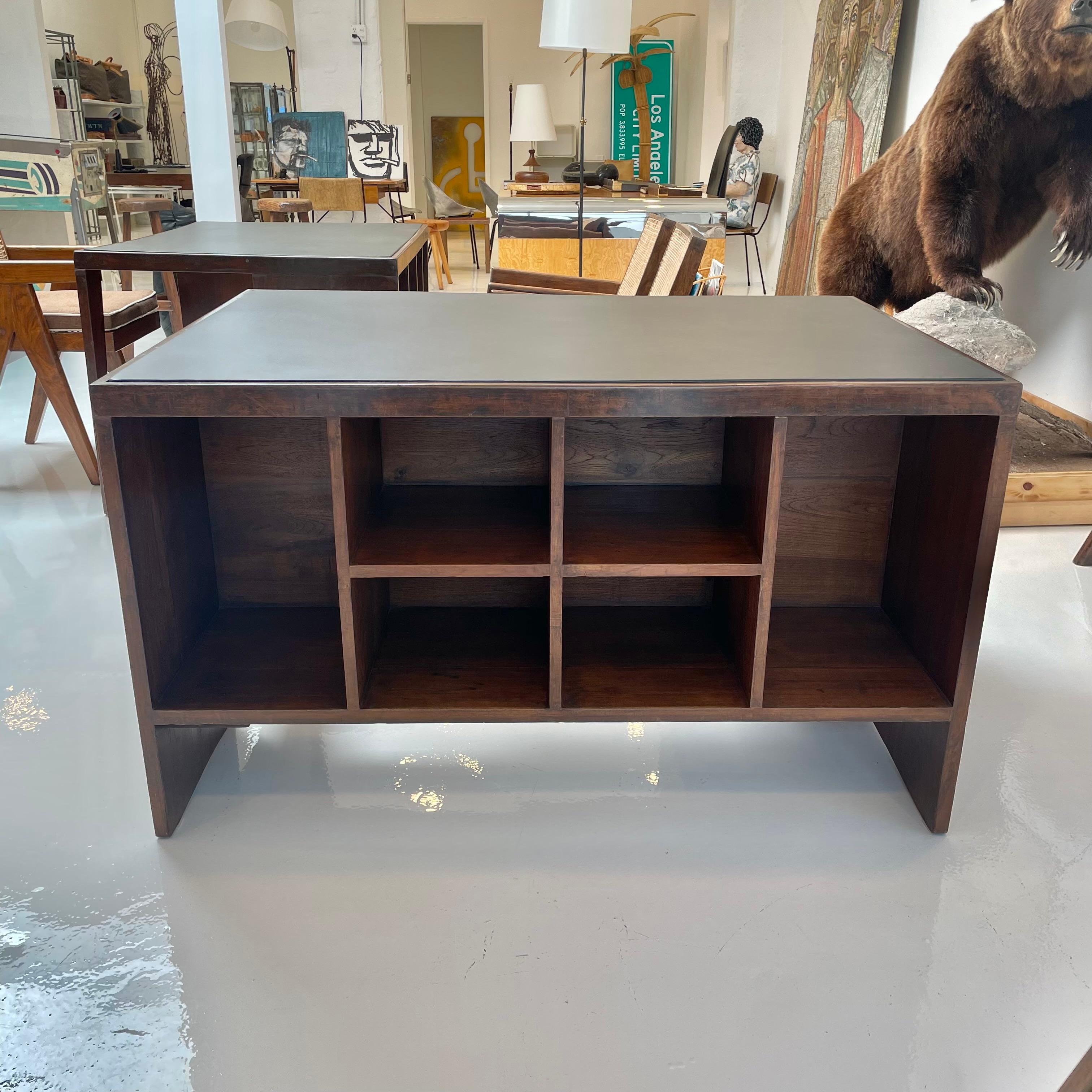 Spectacular pigeonhole desk by Pierre Jeanneret. Made for the Chandigarh project. Used in the administrative buildings in Chindigargh, Sector 1. Angular leg and bookcase back. One of the most iconic pieces of modern design. Taupe leather top. Single
