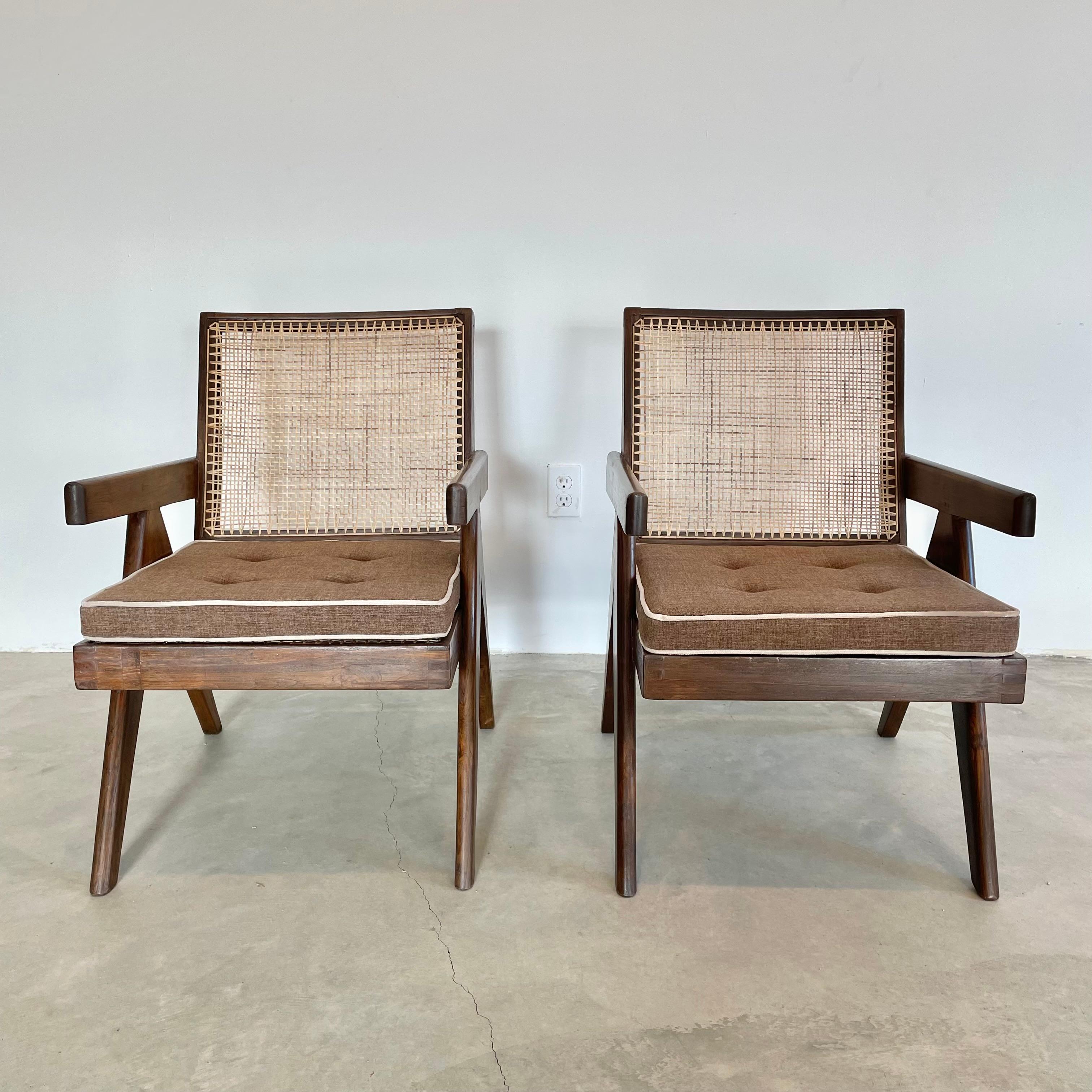 Fantastic collection of Pierre Jeanneret easy chairs / lounge chairs. Model PJ-SI-29-A. Solid teak chairs with compass style legs, cane seat, and cane seat back. Hand stenciling on the back of both chairs reads : Ch.L.(P)-063 and Ch.L.(P)-033