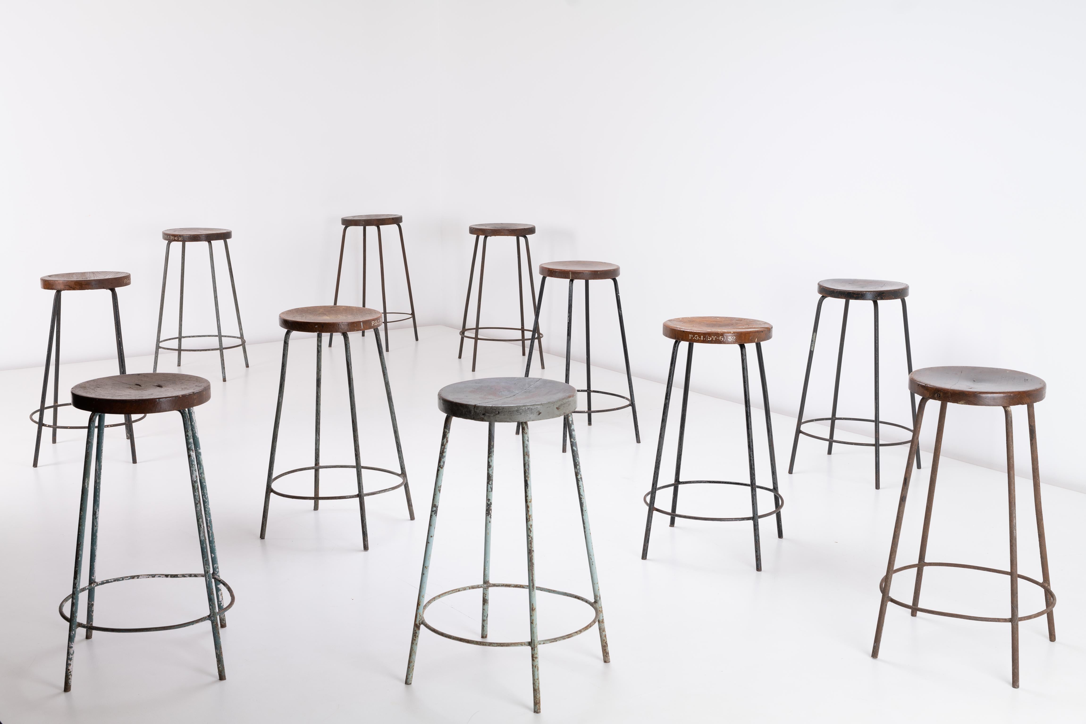 Pierre Jeanneret’s High stools for the Post Graduate Institute, Chandigarh, India. The stools have a solid teak concaved top with a rich dark patina fitted to a painted, tripod iron base. The pieces are well used, show heavy signs of wear, light