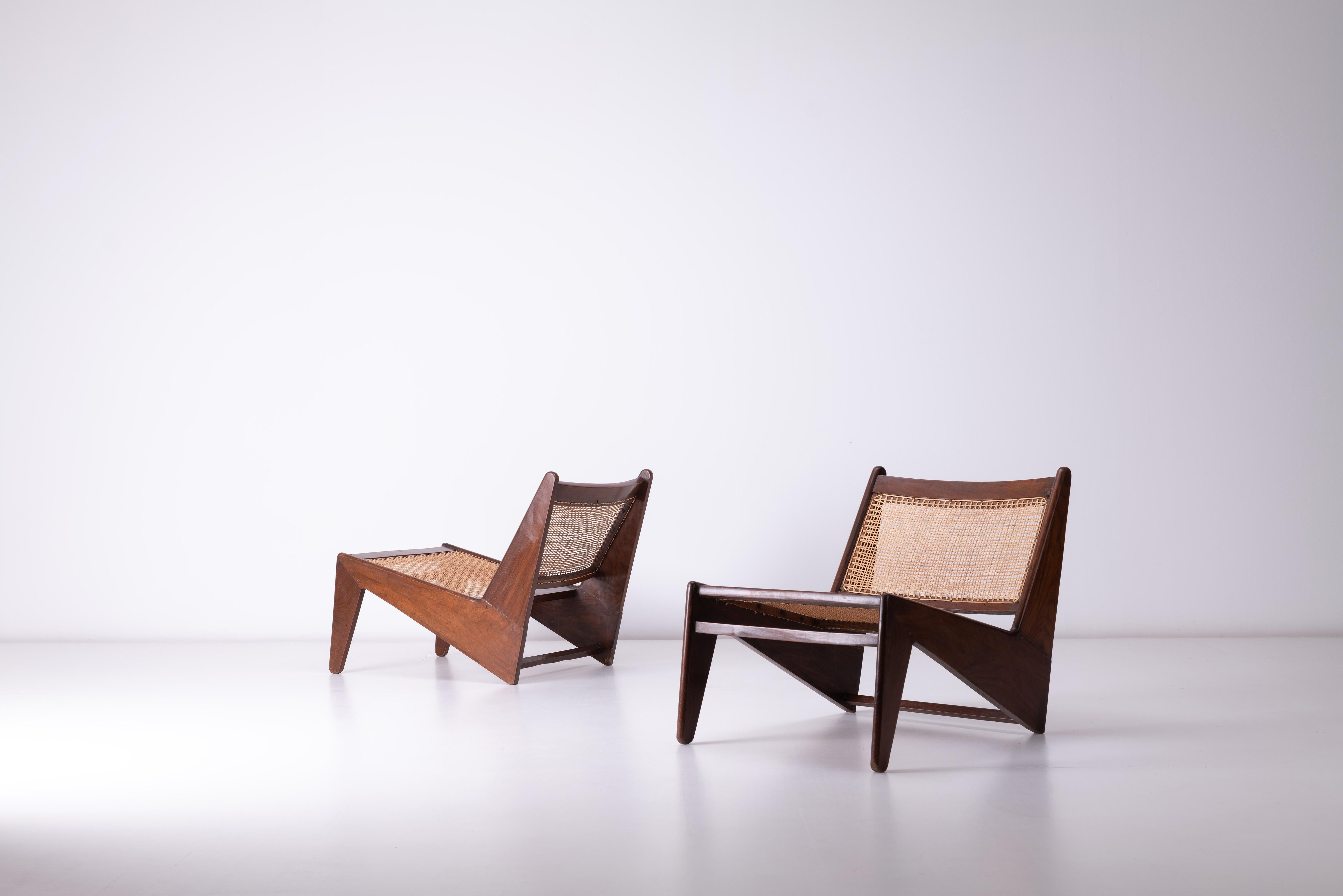 This pair of vintage Pierre Jeanneret Kangaroo chairs is a remarkable example of mid-century modern design and a rare piece of architectural history. Designed by Swiss architect Pierre Jeanneret in collaboration with Le Corbusier, these chairs were