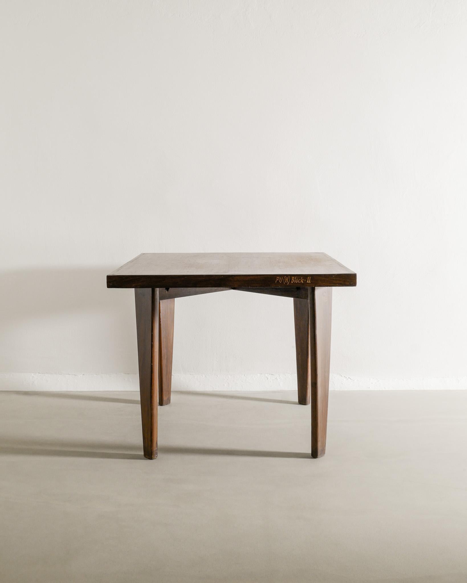 A very rare French mid century squared wooden dining center table in teak by Pierre Jeanneret & Le Corbusier produced for Chandigarh / Punjab India, 1950s. In good vintage condition with patina from age and use. A nice and decorative lettering on