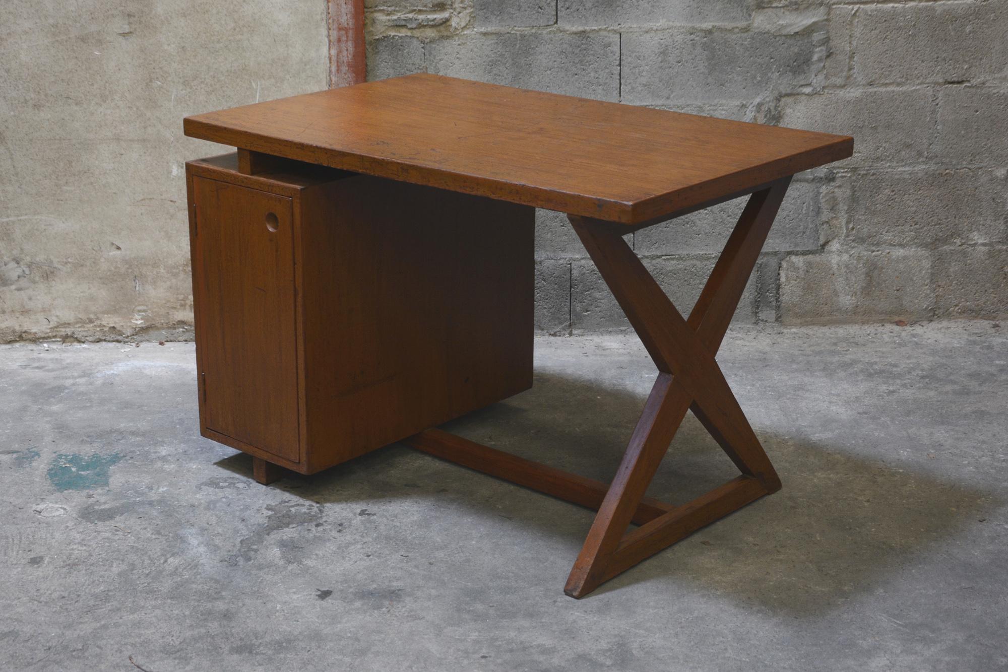 Pierre Jeanneret, rare X-shaped leg Desk designed for various administrative buildings in Chandigarh, India

Tabletop covered with plated teak inset fixed on a X-shaped leg. 4 drawers on front. Very nice patina. An iconic Pierre Jeanneret piece and