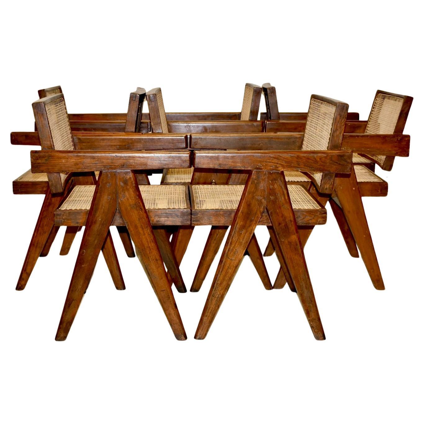 A beautiful set of 8 Pierre Jeanneret floating back office chairs in solid teak.  All chairs are in good vintage condition. 
The braided canework has been replaced.
These iconic pieces were part of the administrative buildings in Chandigarh.
The