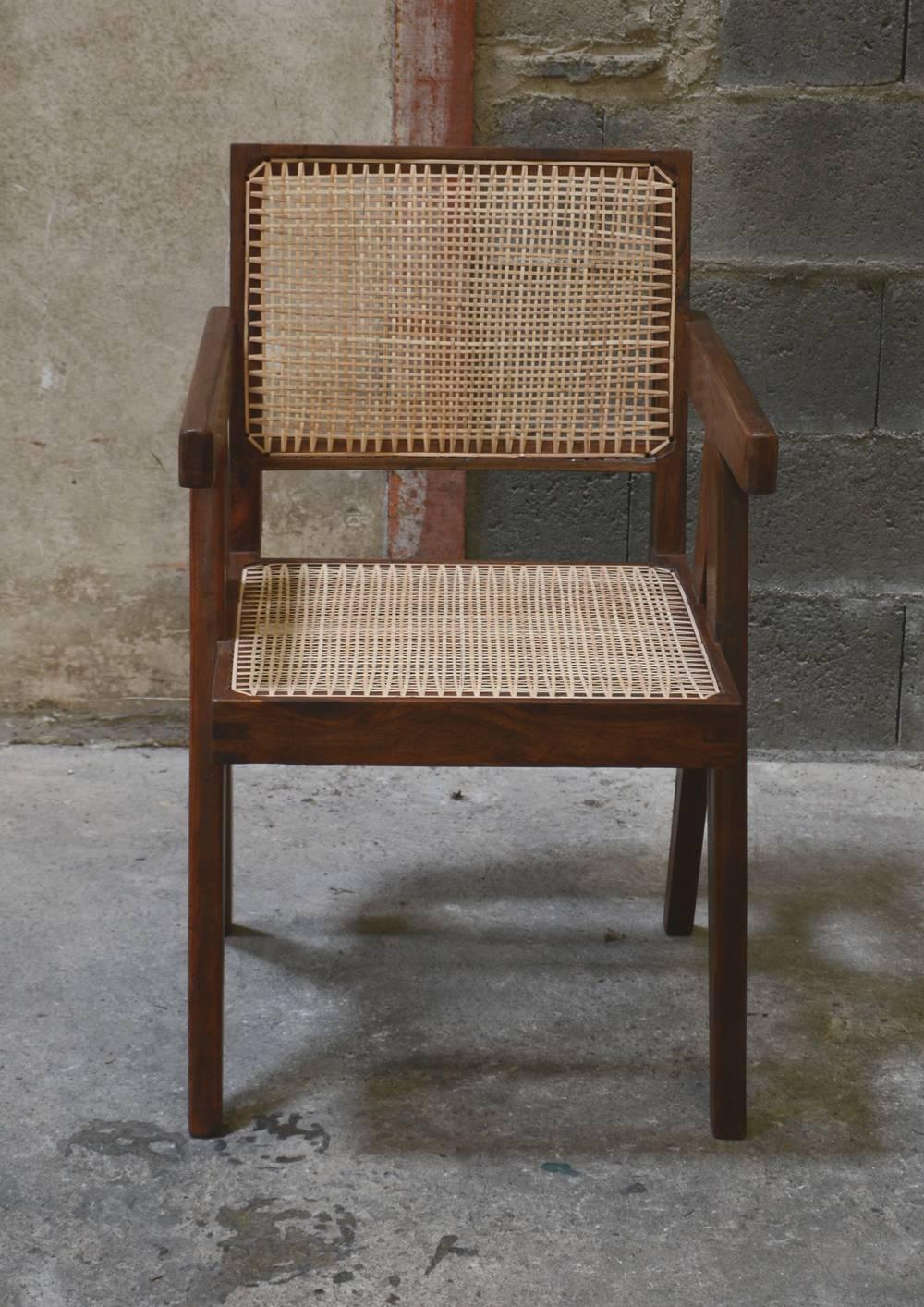 Pierre Jeanneret, cane and teak wood office armchair from administrative buildings in Chandigarh, India. Version with back jointed to the seat by large spindle pieces. Teak, woven cane and upholstered seat cushion featuring cloth covering. Photo