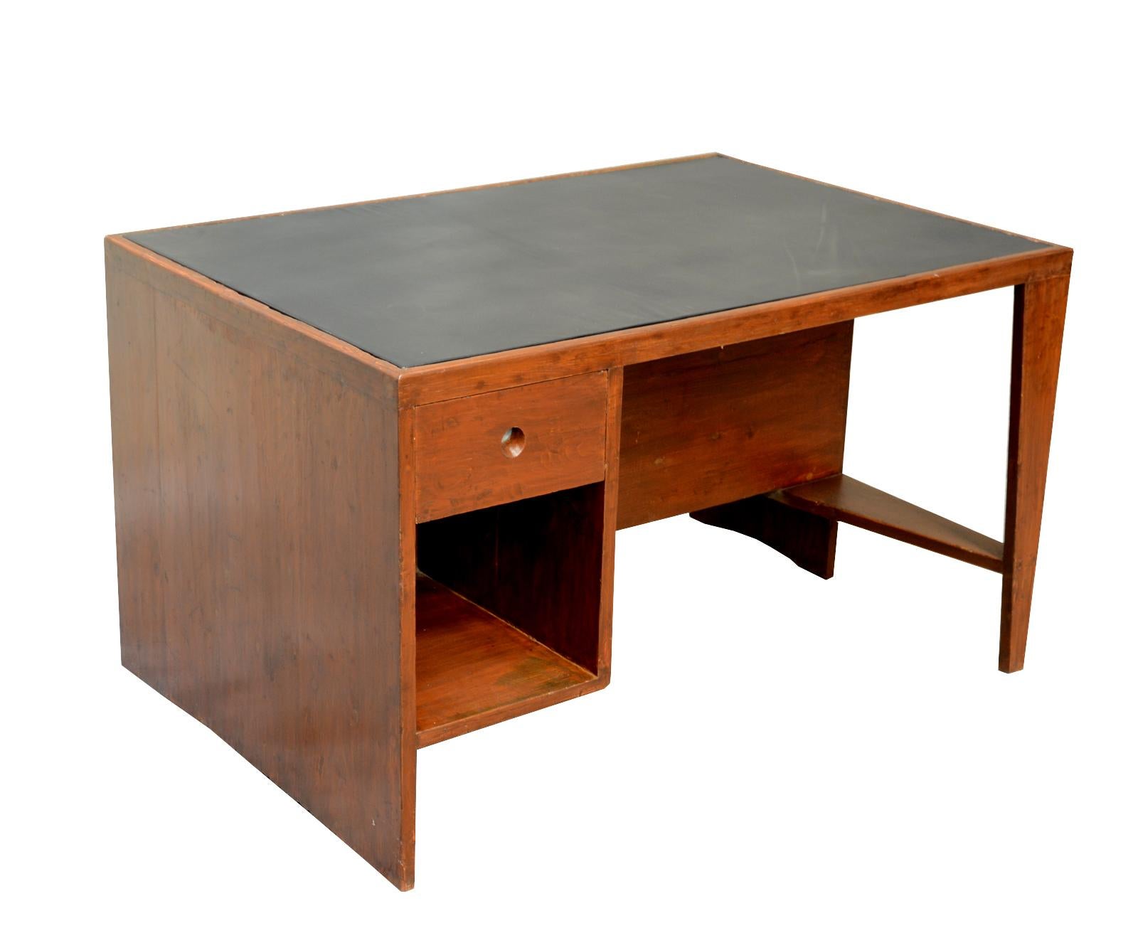 Pierre Jeanneret, office table for various administrative buildings in Chandigarh, India.
Tabletop covered with black leather. Spindle-shaped leg, drawer element on front, six open compartments on rear. Very nice patina.
Possibility to sell it