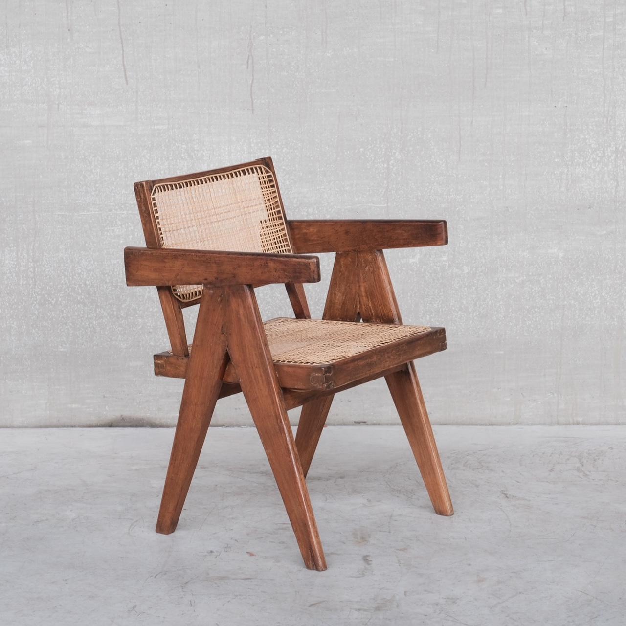 An authentic Pierre Jeanneret office or desk chair. 

Teak and cane. 

India, Chandigarh, c1960s. 

A flexible piece of design history that can be used in bedrooms, lounges etc. - any where it sits it will command attention. 

Re-caned as