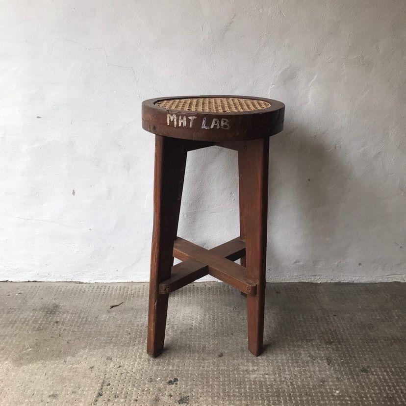 A lab stool by French design legend Pierre Jeanneret.

Teak and cane.

In original unpolished condition.

Highly collectable and increasingly scarce. Original writing.

India, circa 1965 for Chandigarh. One of two in stock.

Vintage