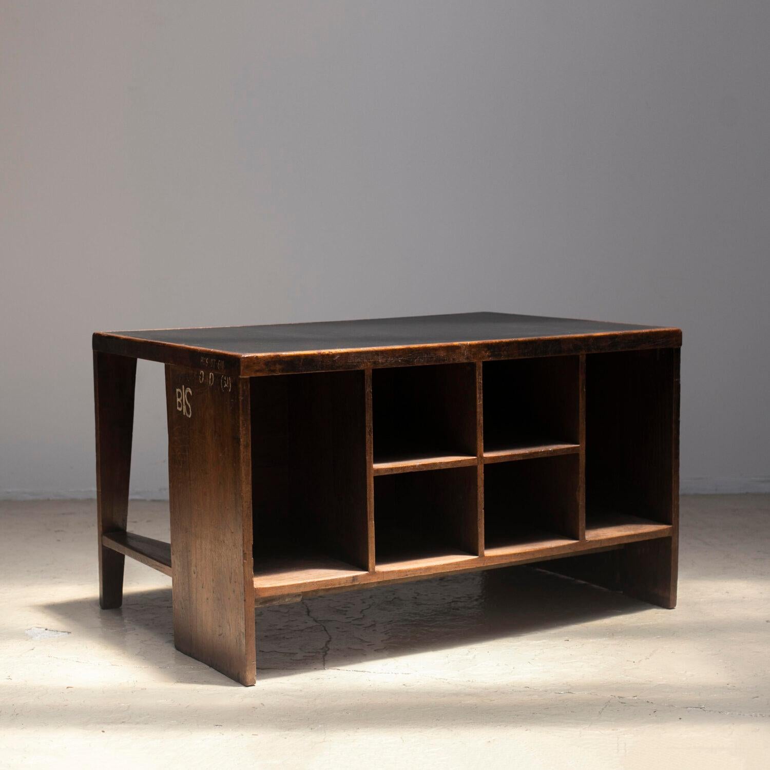 Pigeonhole desk designed by Pierre Jeanneret for the High Court, Legislative Assembly and various administrative bodies in Chandigarh. 1957-58s. Wood and faux leather. The top is re-covered with black faux leather.

Provenance: High Court,