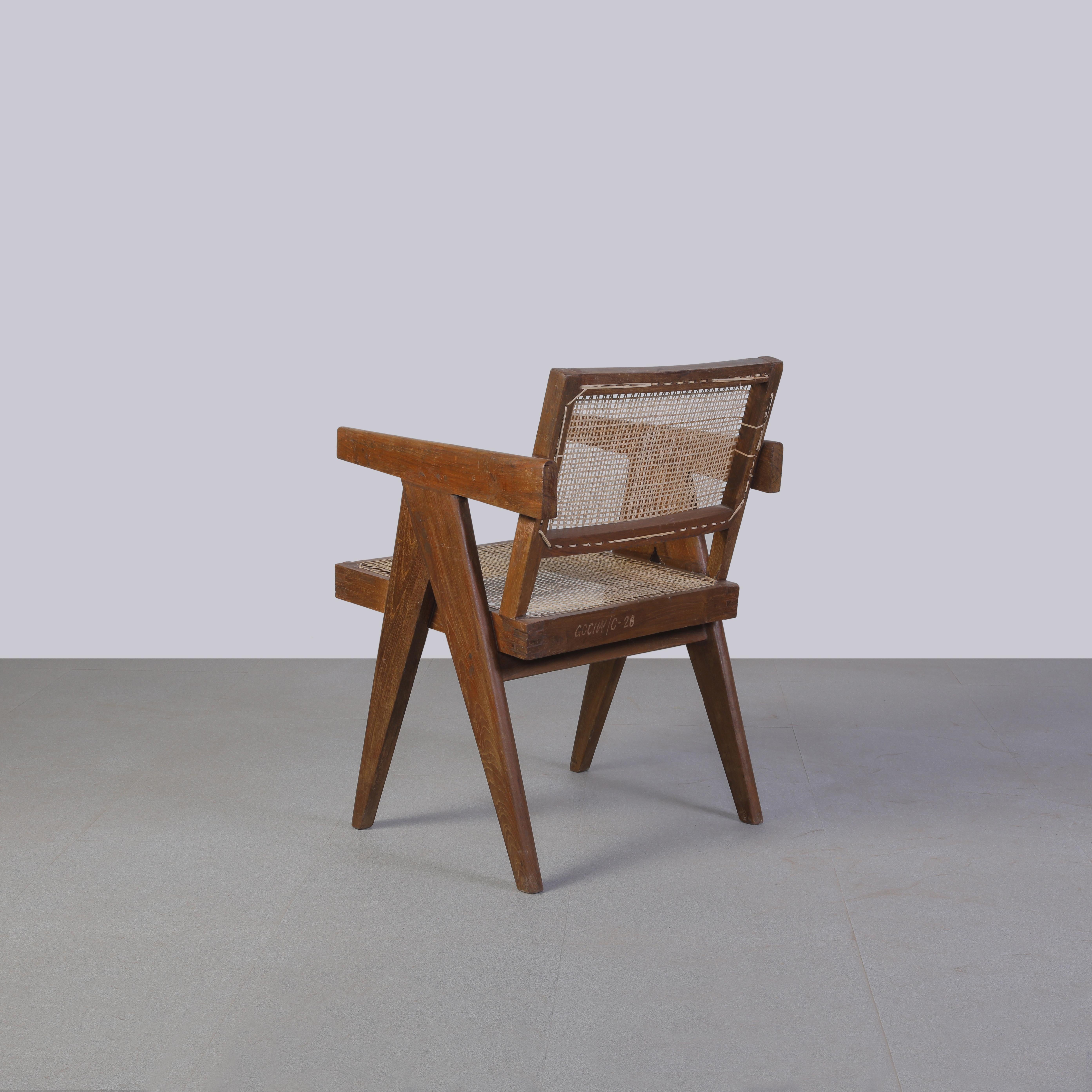 Chair has patinated teak, which gives that chair a strong character, showing all that traces of age and its uniqueness. This piece has authentic letters on the backside that makes it even more valuable, showing a part of the history of Chandigarh.