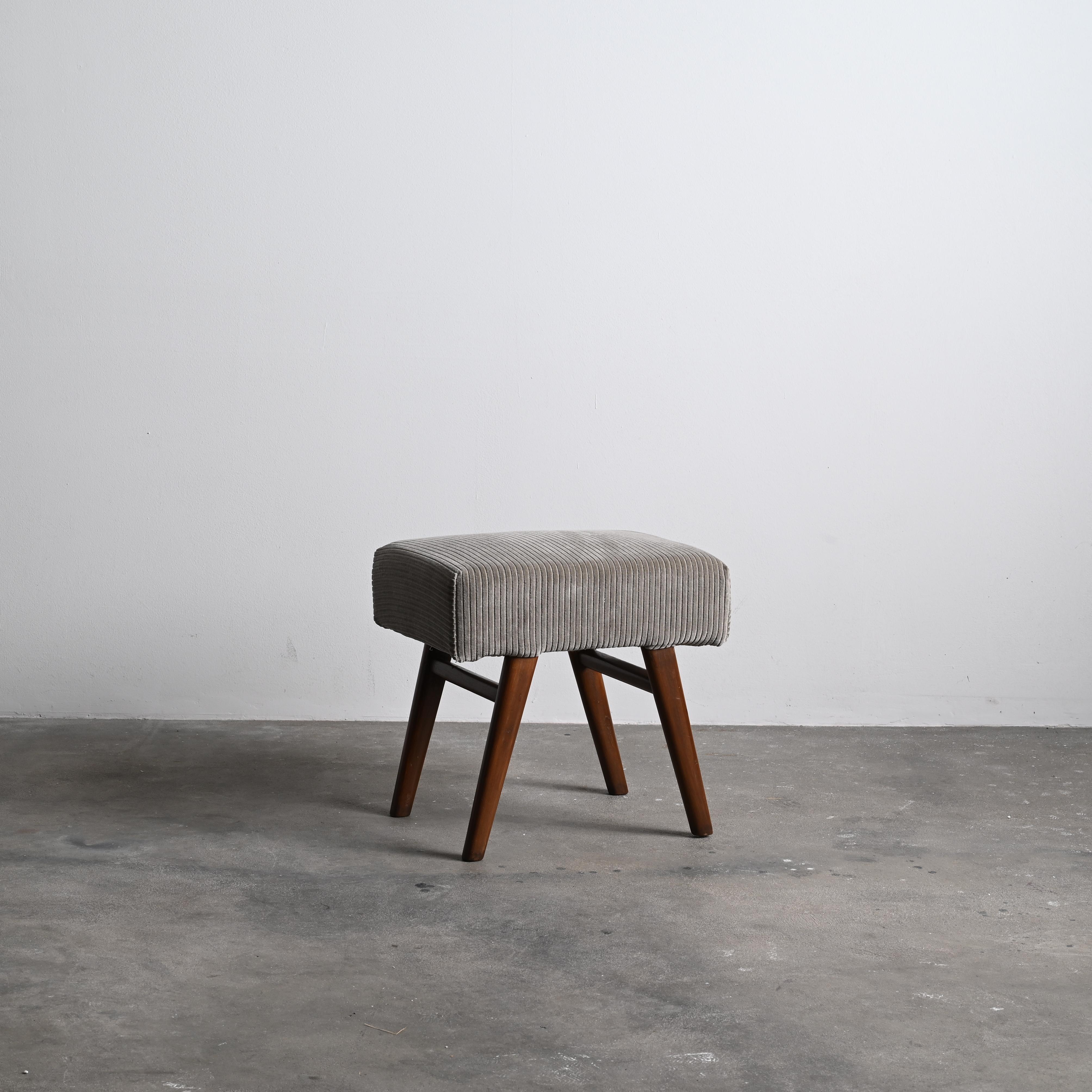 This rectangular low stool is an adorable piece of modernist furniture. It is raw in its simplicity, nothing too much but still nothing is missing. 
Upholstery is redone, but on the request can be changed in accordance with your preferences.