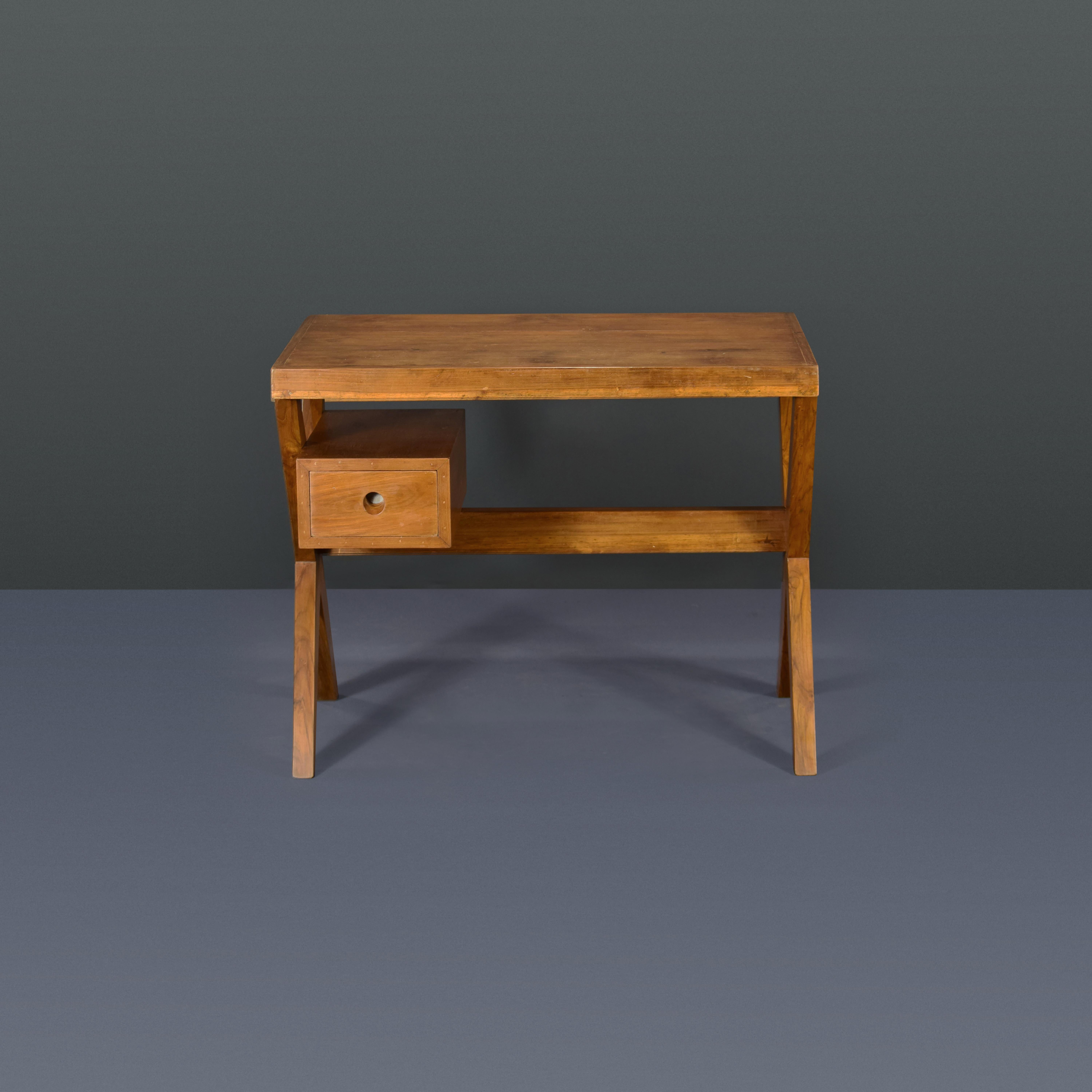 This desk is raw in its simplicity, embodying an expressing the pure ideas of Pierre Jeanneret. It is a very strong piece which I love very much, its limited to the elements it needs: drawers, top and a X-leg to hold the second side of the desk.