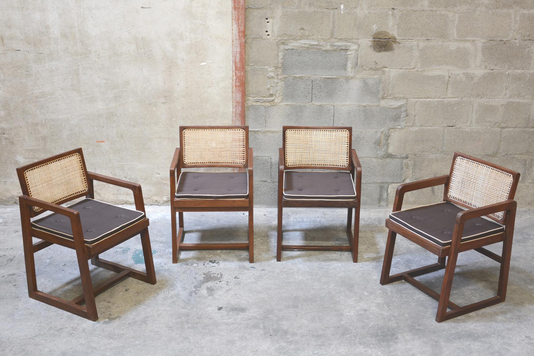 Pierre Jeanneret, rare set of 4 cane and teak wood chairs designed for P.U. University Library in Chandigarh (1966), India. Teak, woven cane and upholstered new seat cushion featuring cloth covering. 

3 Chairs have their original lettering (see
