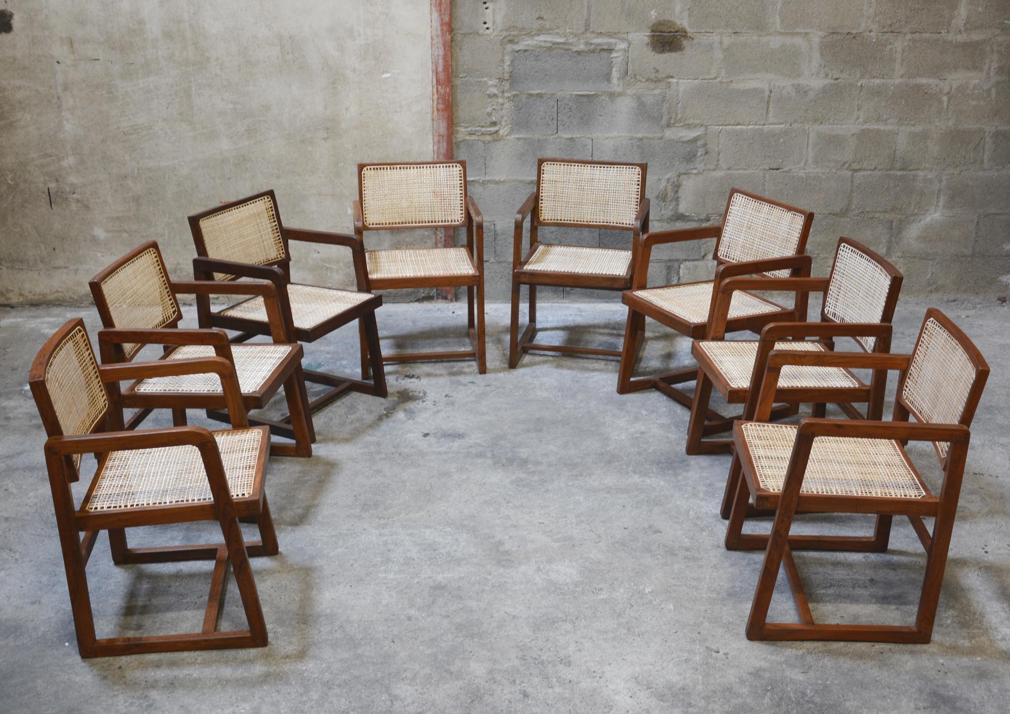 Pierre Jeanneret, rare set of 8 cane and teakwood Chairs designed for P.U. University Library in Chandigarh (1966), India. Teak, woven cane and upholstered new seat cushion featuring cloth covering. 

7 Chairs have their original lettering (see