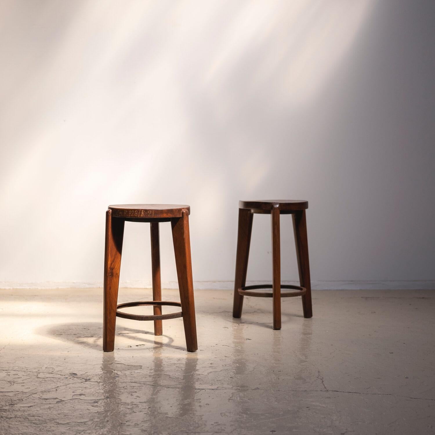 Round stool designed by Pierre Jeanneret. 1960-1965.
The seat are made with thick solid teak wood. Three tapered legs, also made with solid teak wood, are connected with an iron leg rest.
The price shown is per item.
 