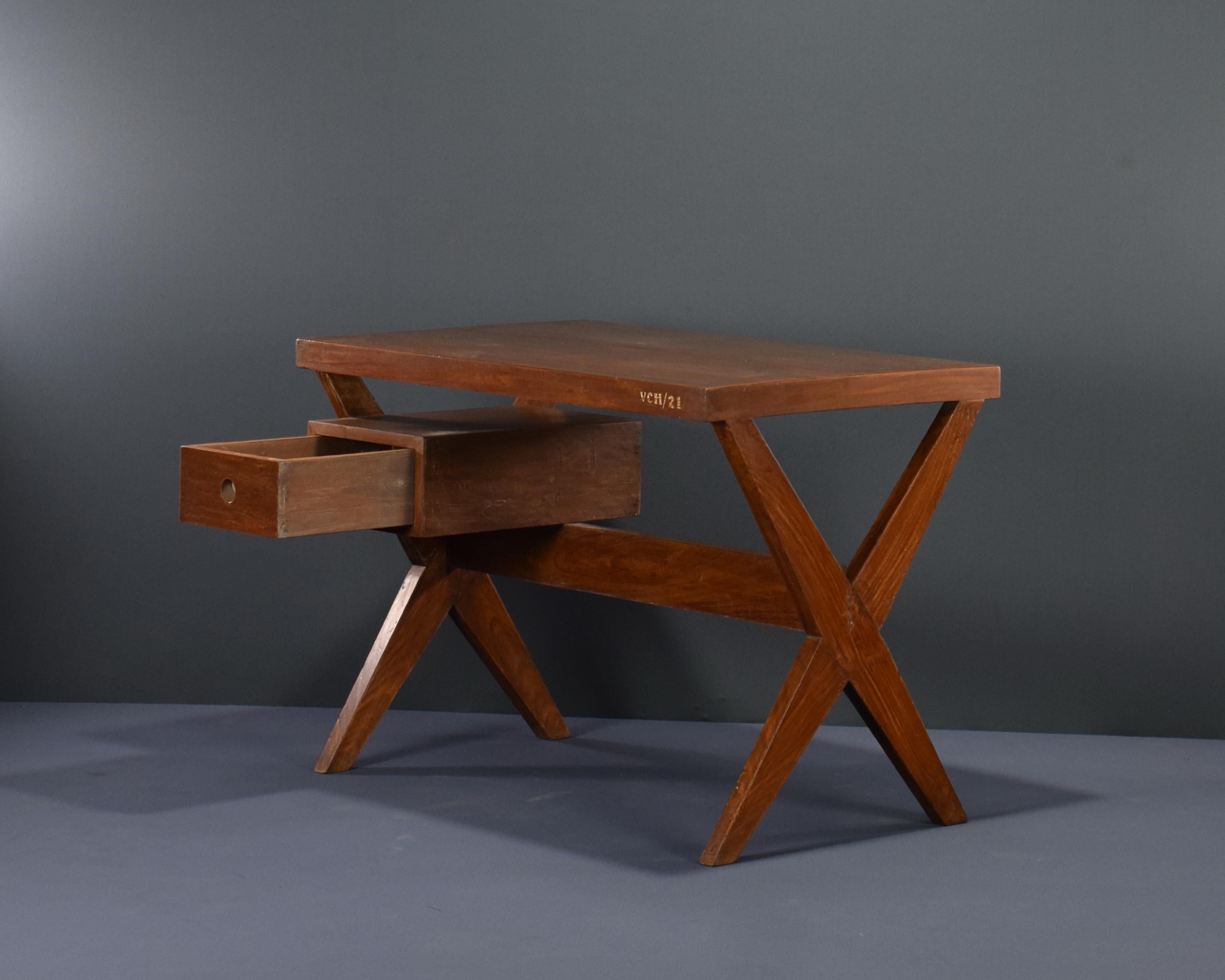 This desk is raw in its simplicity, embodying an expressing the pure ideas of Pierre Jeanneret. It is a very strong piece which I love very much, its limited to the elements it needs: drawers, top and a X-leg to hold the second side of the desk.