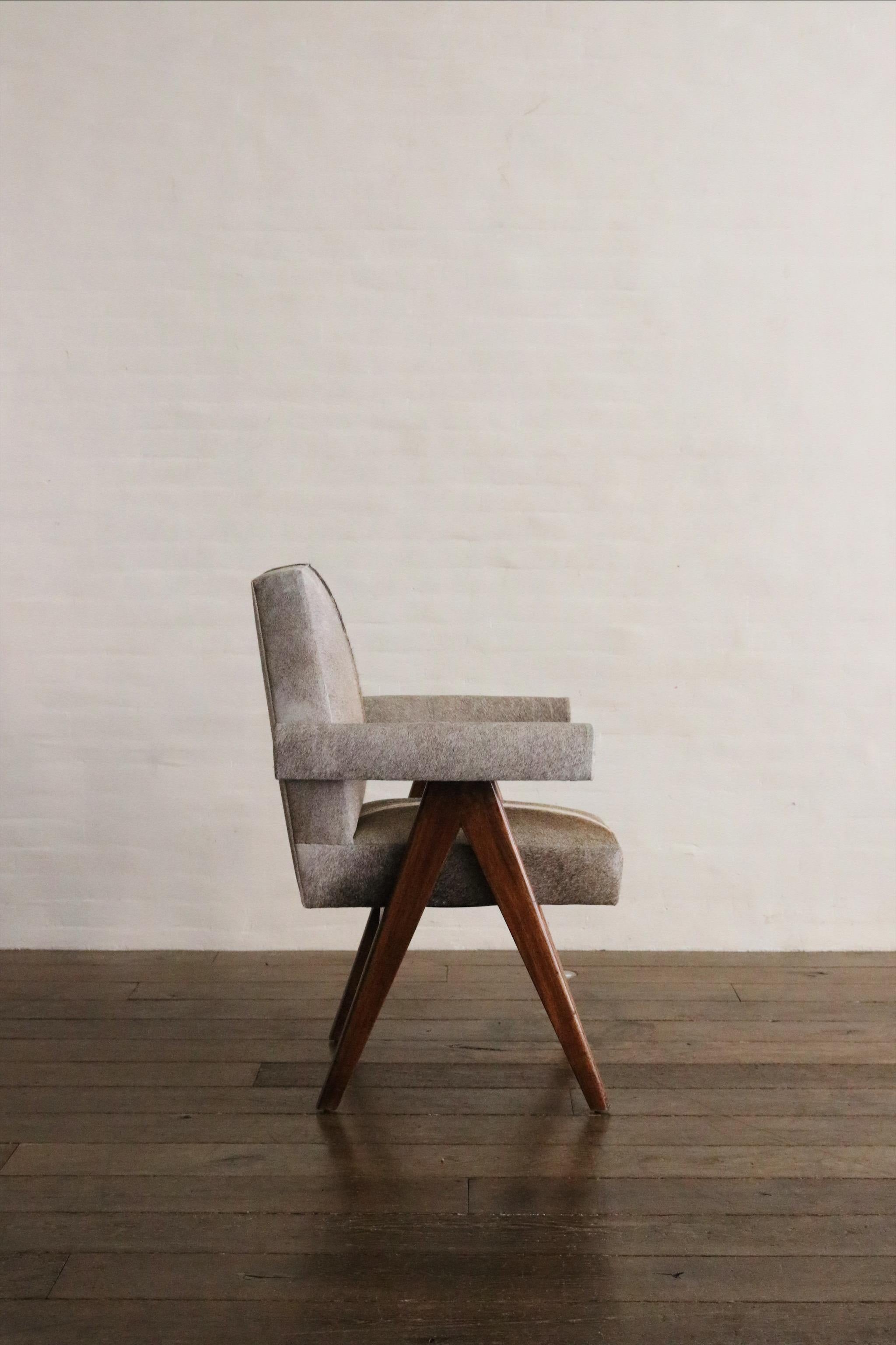 Then PJ-SI-30-C - Pierre Jeanneret Senate - Committee Arm Chair beautifully re-upholstered in natural hair on hide. This chair is renown for its stunning silhouette and form, the stunning profile and beautiful leg details make this an iconic piece