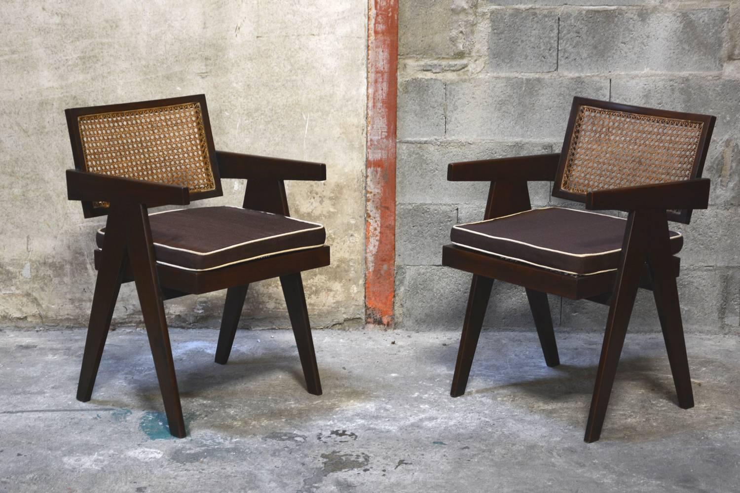 Pierre Jeanneret, set of two cane and teak wood office armchairs from administrative buildings in Chandigarh, India. Version with back separated from the seat. Teak, woven cane and upholstered seat cushion featuring cloth covering.
Original