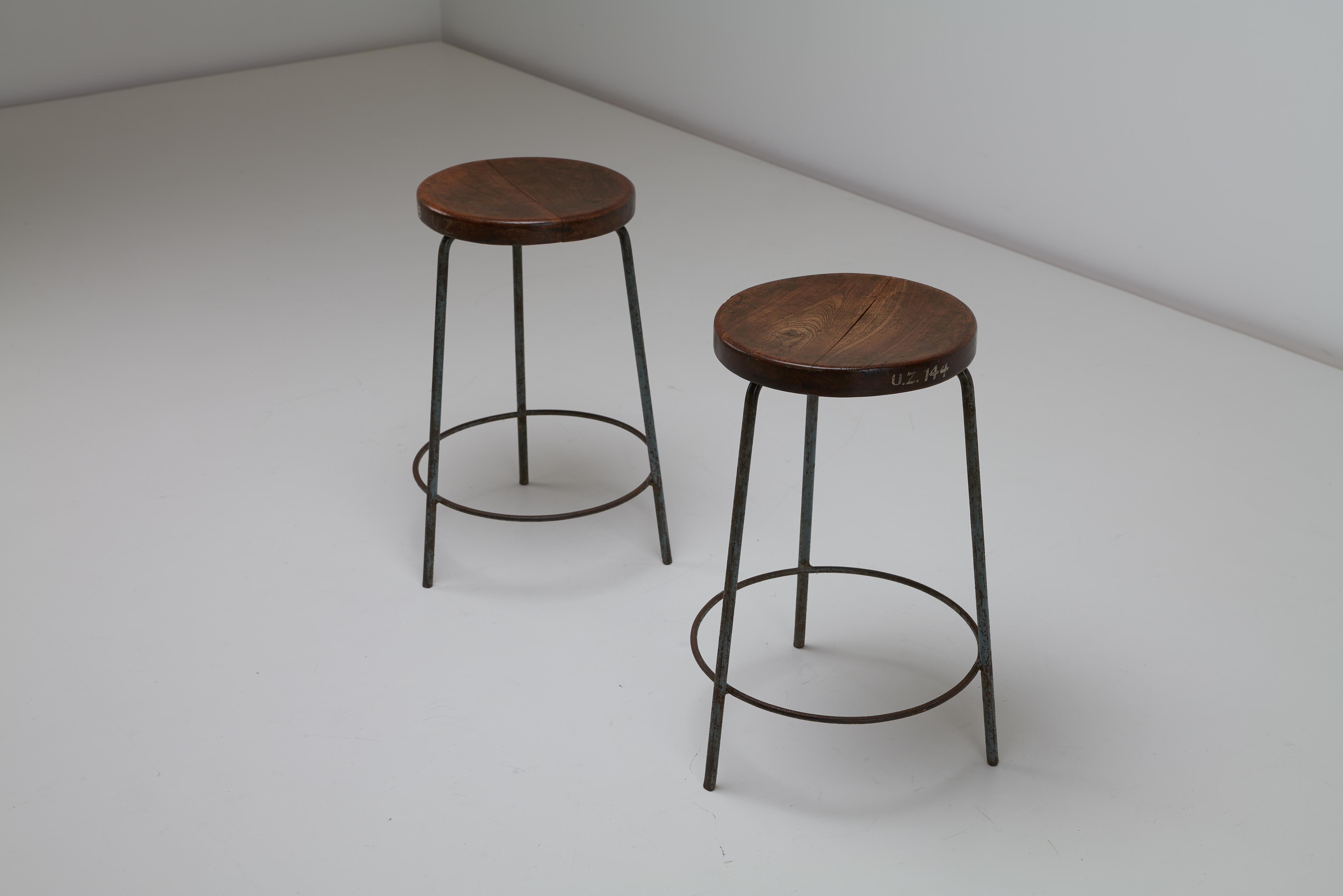 Pierre Jeanneret’s medium height stools for the Punjab University, Chandigarh, India. The stools have a solid teak concaved top with a rich dark patina fitted to a painted, iron base. The pieces are well used, show heavy signs of wear, light