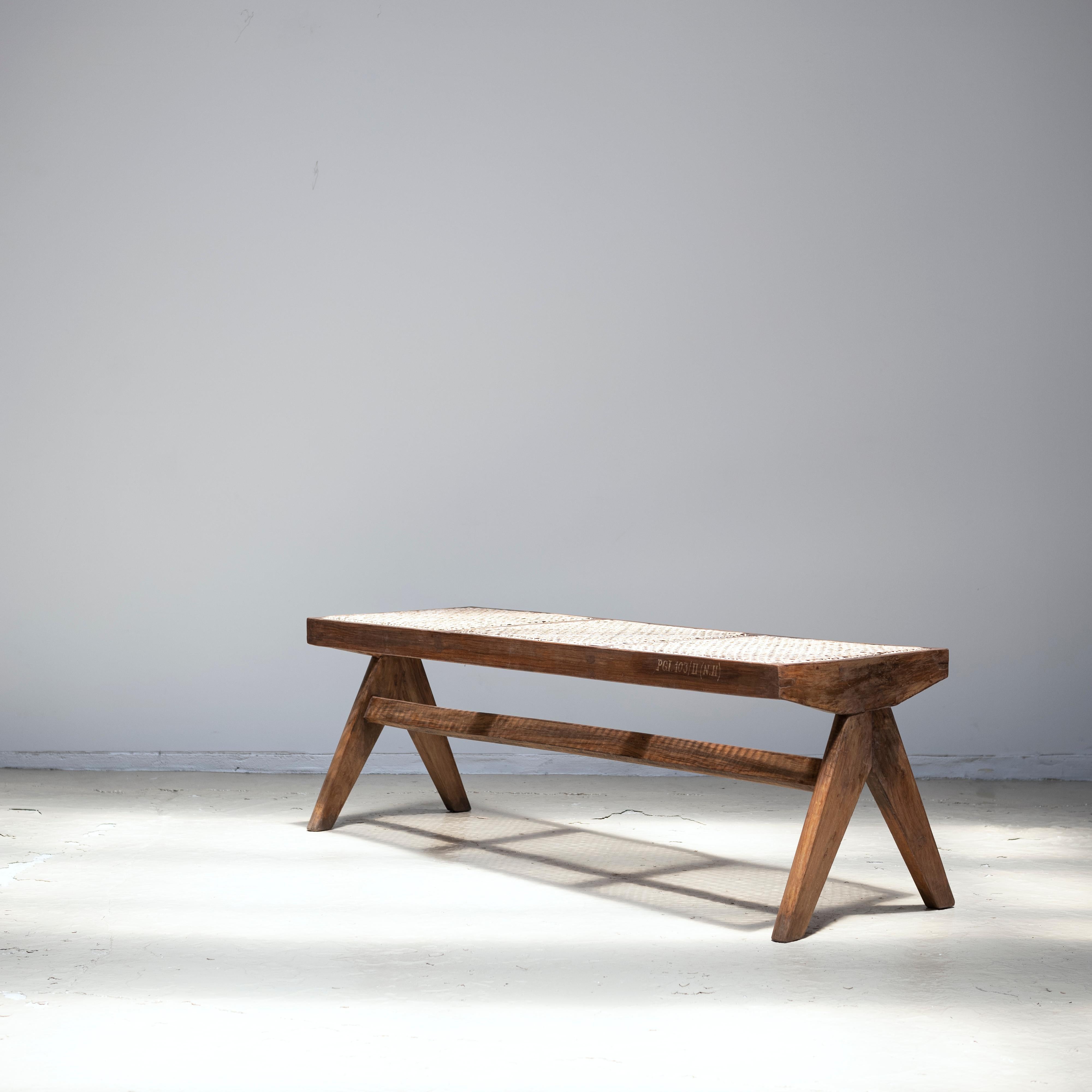 A bench in solid teak wood and cane designed by Pierre Jeanneret.
Circa 1955.
Provenance: Post-Graduate Institute, Chandigarh, India
 