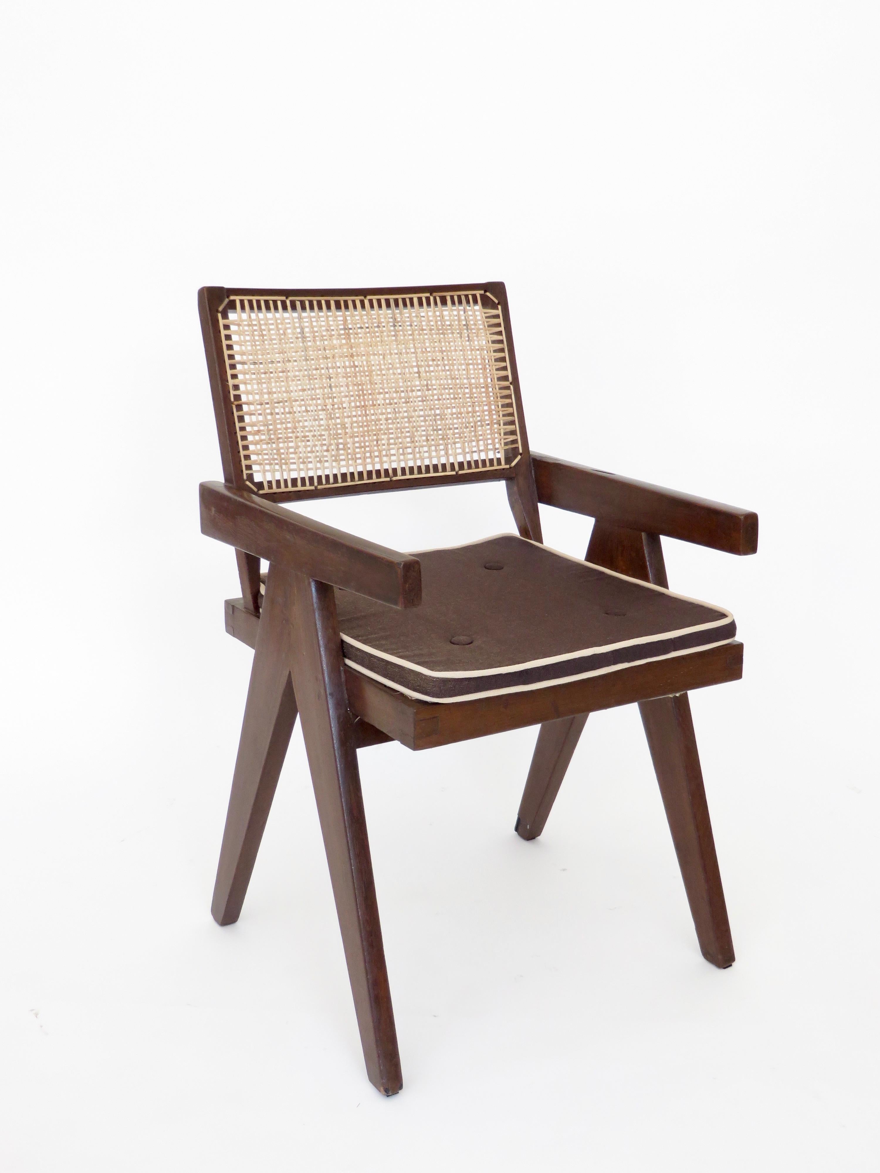 A single armchair called office cane chair by Pierre Jeanneret (1896-1967) from Chandigarh.
In teak with cushion and with bended and slightly curved back.
Cane seat and back, circa 1956. New caning. All of these chairs from Chandigarh have new