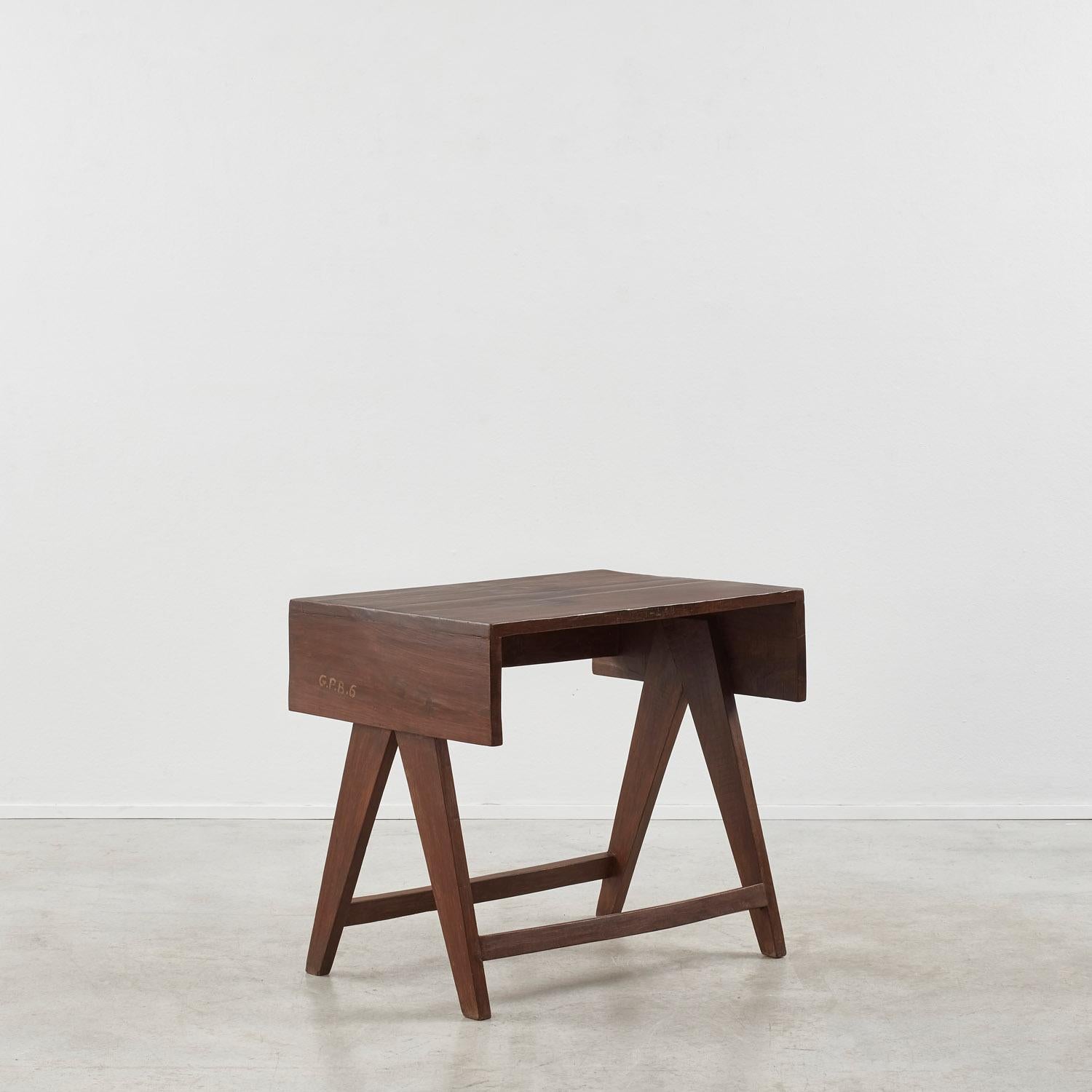 This student desk by Pierre Jeanneret – known as model PJ-BU-08-B – features a rectangular top with drop-down sides, complete with compass-style legs.

Geneva-born architect Pierre Jeanneret (b.1896–1967) is best known for his decades-long