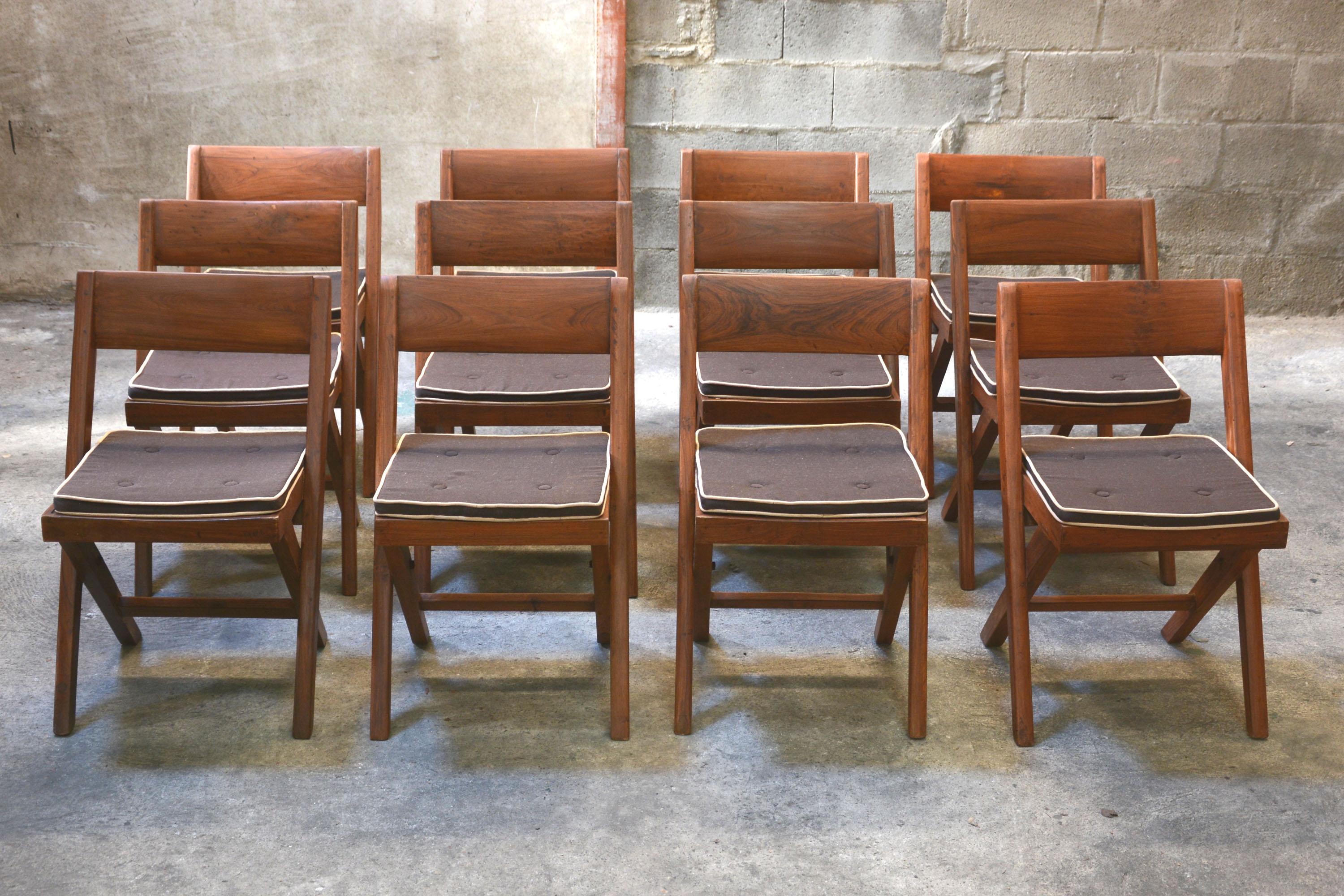 Pierre Jeanneret, unique set of 12 library chairs for the court building and the University Library in Chandigarh, India. Teak, woven cane and upholstered seat cushion featuring cloth covering. 11 Chairs have their original lettering, one Chair has