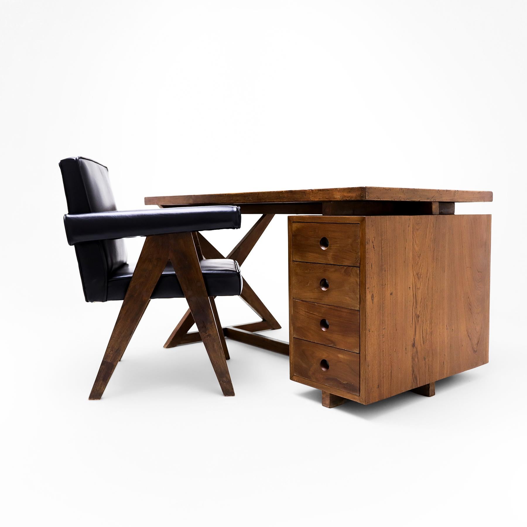 An original Pierre Jeanneret X frame teak and leather Administrative Desk from the Civic buildings of Chandigarh, India, matched to a fully upholstered Model ‘Pj Si 30 A’ Committee Chair.  

Hand-crafted from Burmese teakwood, this vintage Jeanneret