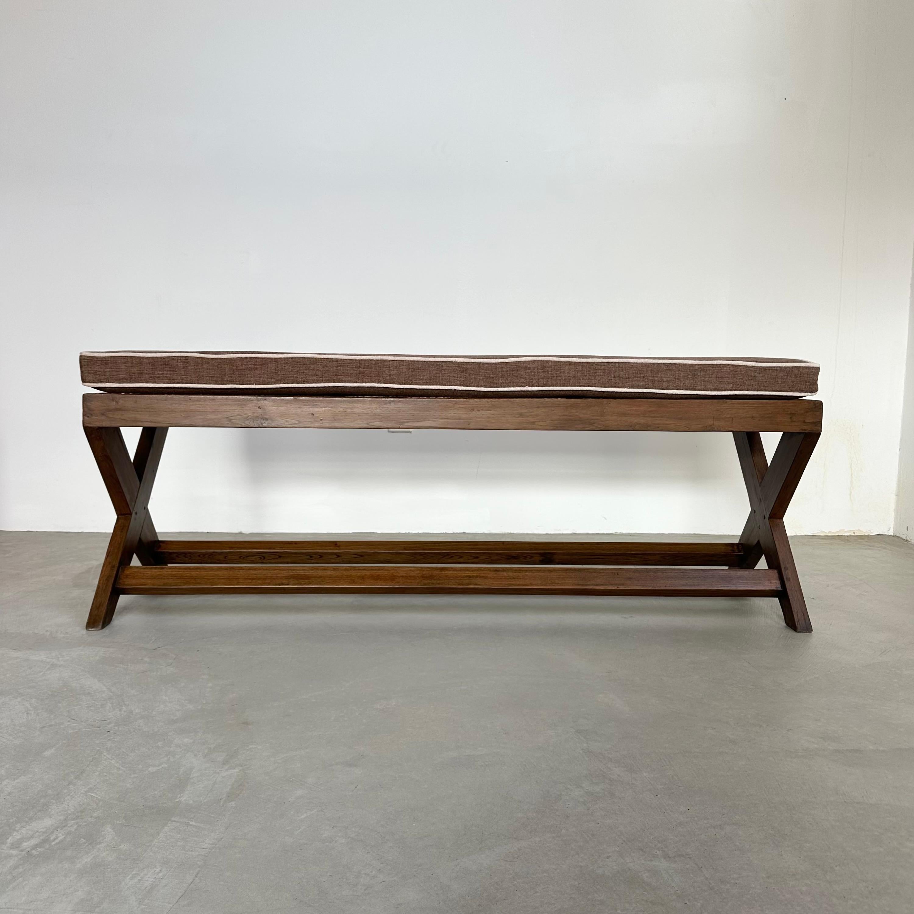 Beautiful teak bench titled the King Bench X Leg designed by Pierre Jeanneret for Chandigarh. Imported from India with care and fully restored from the 1950s. This particular bench is special, as it has a marking on the side that reads 
