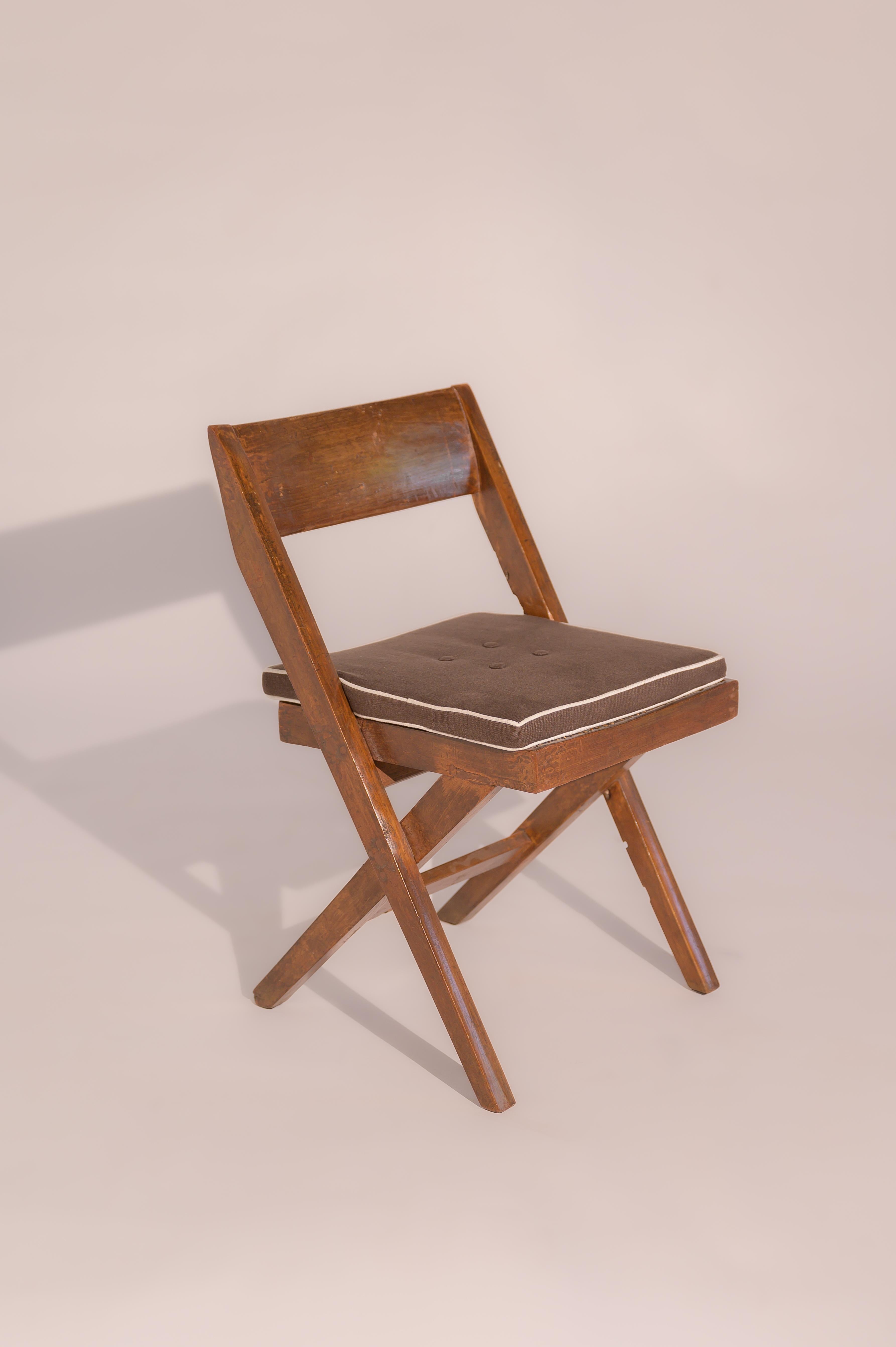 An authentic Chandigarh chair 

Made with pegged solid teak and braided cane work in the 1960s. This type is known as the Library chair. The original lettering and numbering - referring to their place in one of the government buildings still