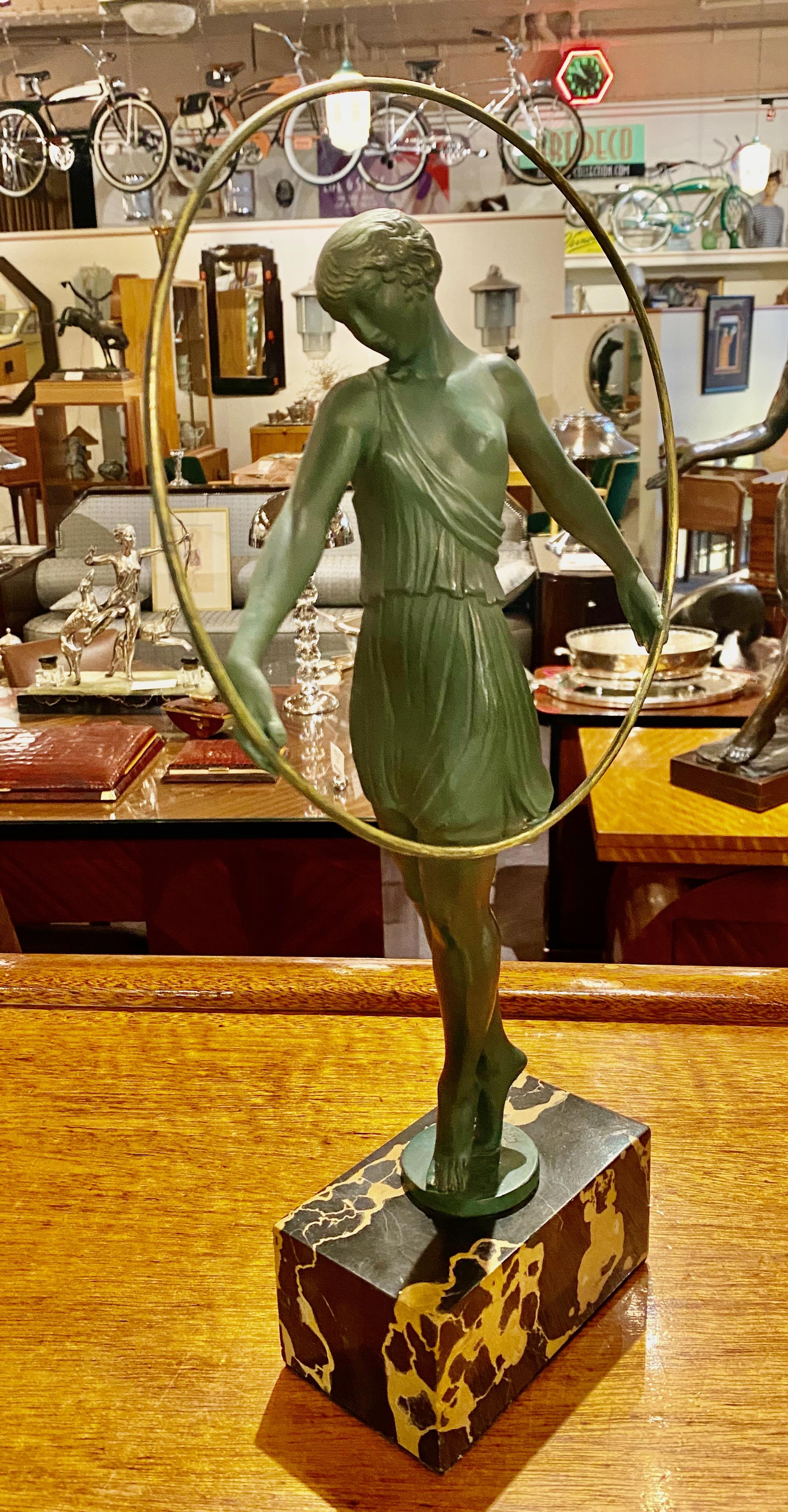 Pierre Le Faguays dancer with hoop Art Deco verdigris patented sculpture. Le Verrier foundry. Fayral signature (Pseudonym of Pierre Le Faguays) circa 1930. Mounted on portoro marble plinth. There are many examples of hoop dancing art deco female