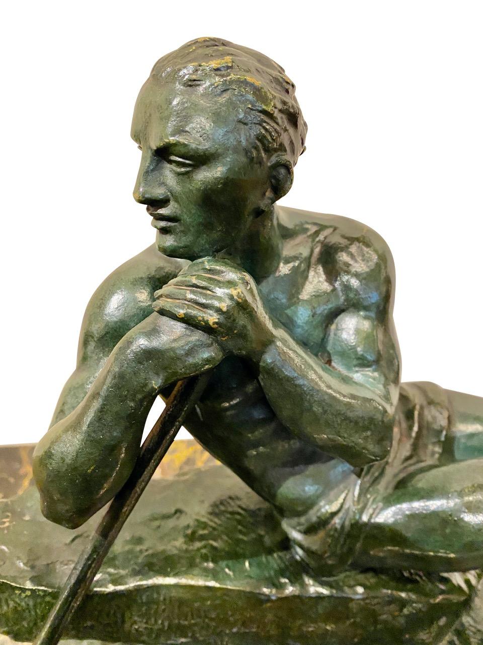 Pierre Le Faguays, French sculptor male figure in green patinated bronze. Modeled as a man wearing a loincloth and leaning on a pole. Tremendous details, unusual texture portrayed in a form rarely seen in his Art Deco sculptures. Signed P Le Faguays