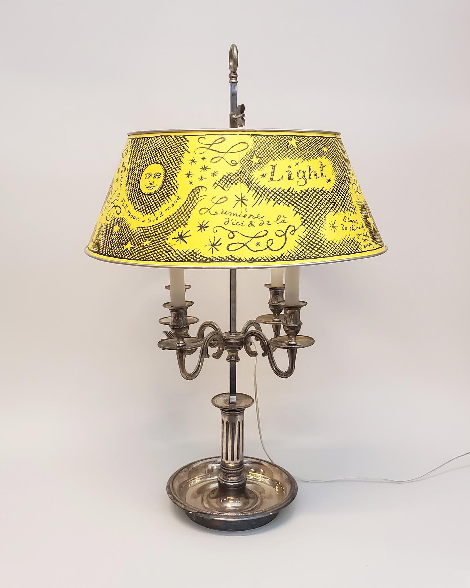 The artist Pierre Le-Tan painted the shade of this antique lamp with words for light in English, French, Latin, Italian, and German – lumière, lux, luce, licht. Being a world-traveler, he spoke a smattering of European languages, in addition to