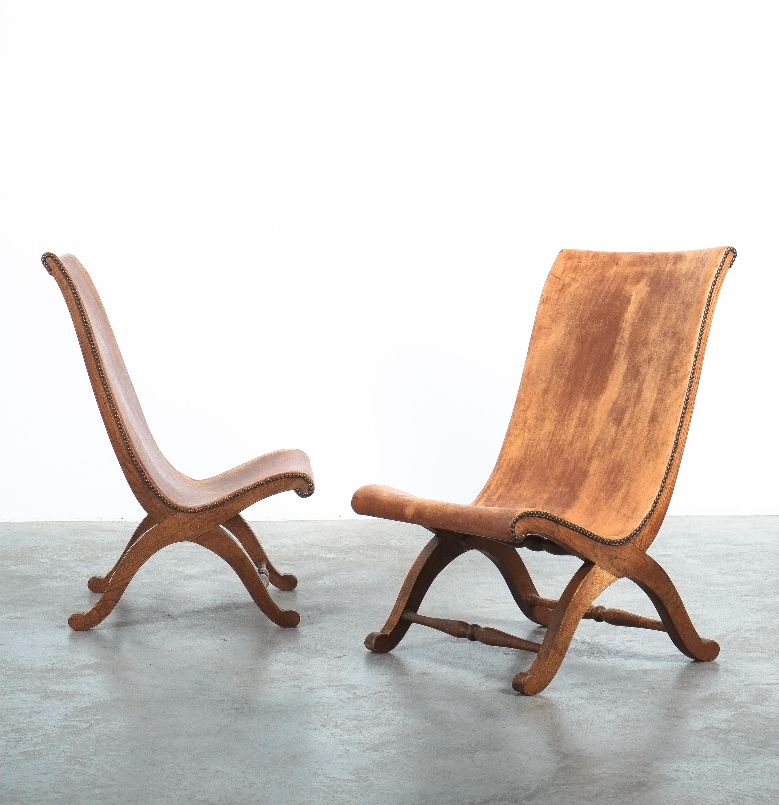 Original, labelled pair of Pierre Lottier chairs for Almazan, Spain Mid Century

Rare high-back version of a pair of cognac leather Butaque oak chairs in original great condition, bearing the makers mark, Valmazan, made in Spain. We admire the