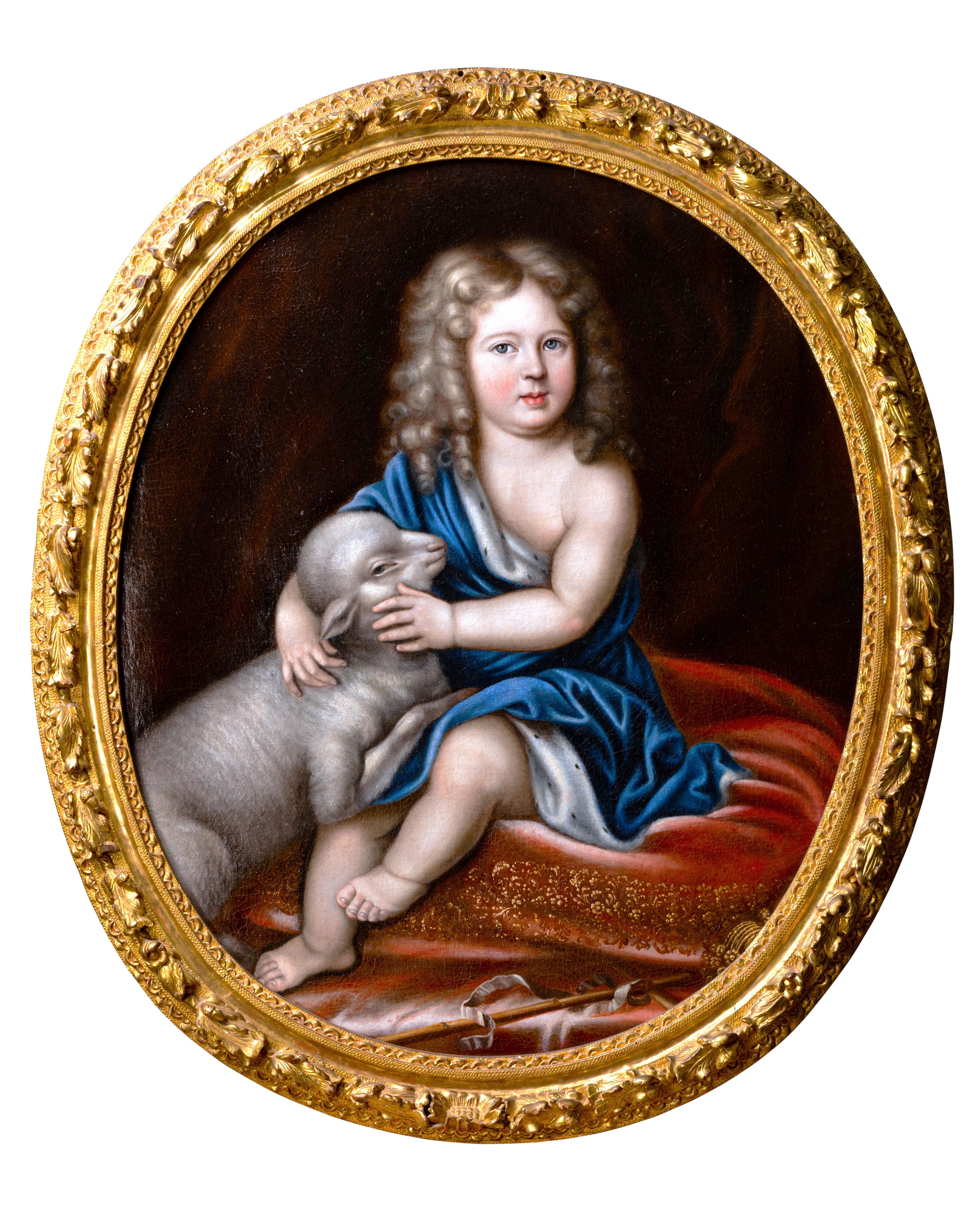 This very charming portrait depicts Philippe V as a child (Duke of Anjou, grandson of Louis XIV and future king of Spain) as Saint John the Baptist.
Installed on a red velvet cushion embroidered with gold, the little boy tenderly embraces a lamb,